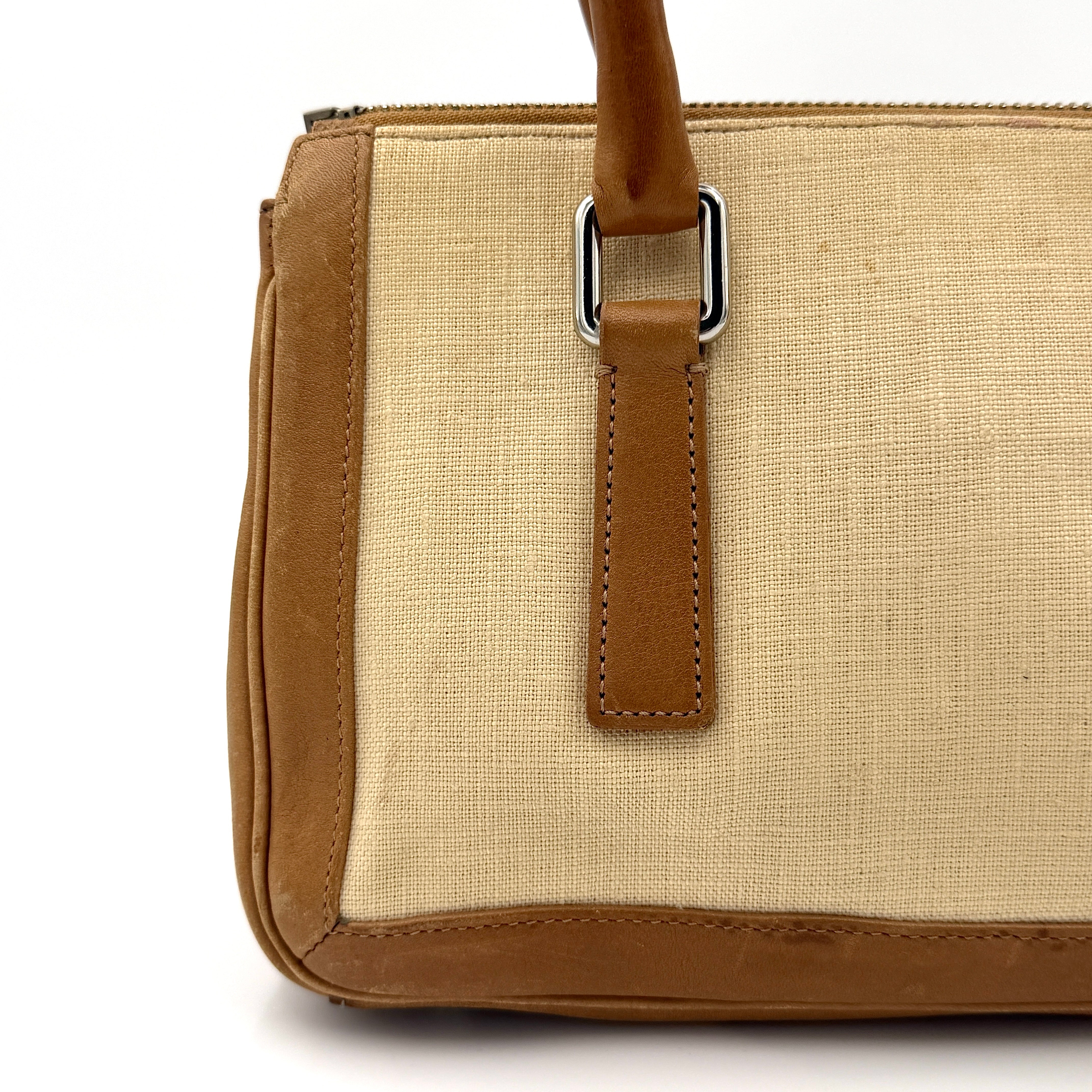 Coach Bonnie Legacy Satchel in beige canvas with caramel leather trim, structured silhouette and dual rolled handles.