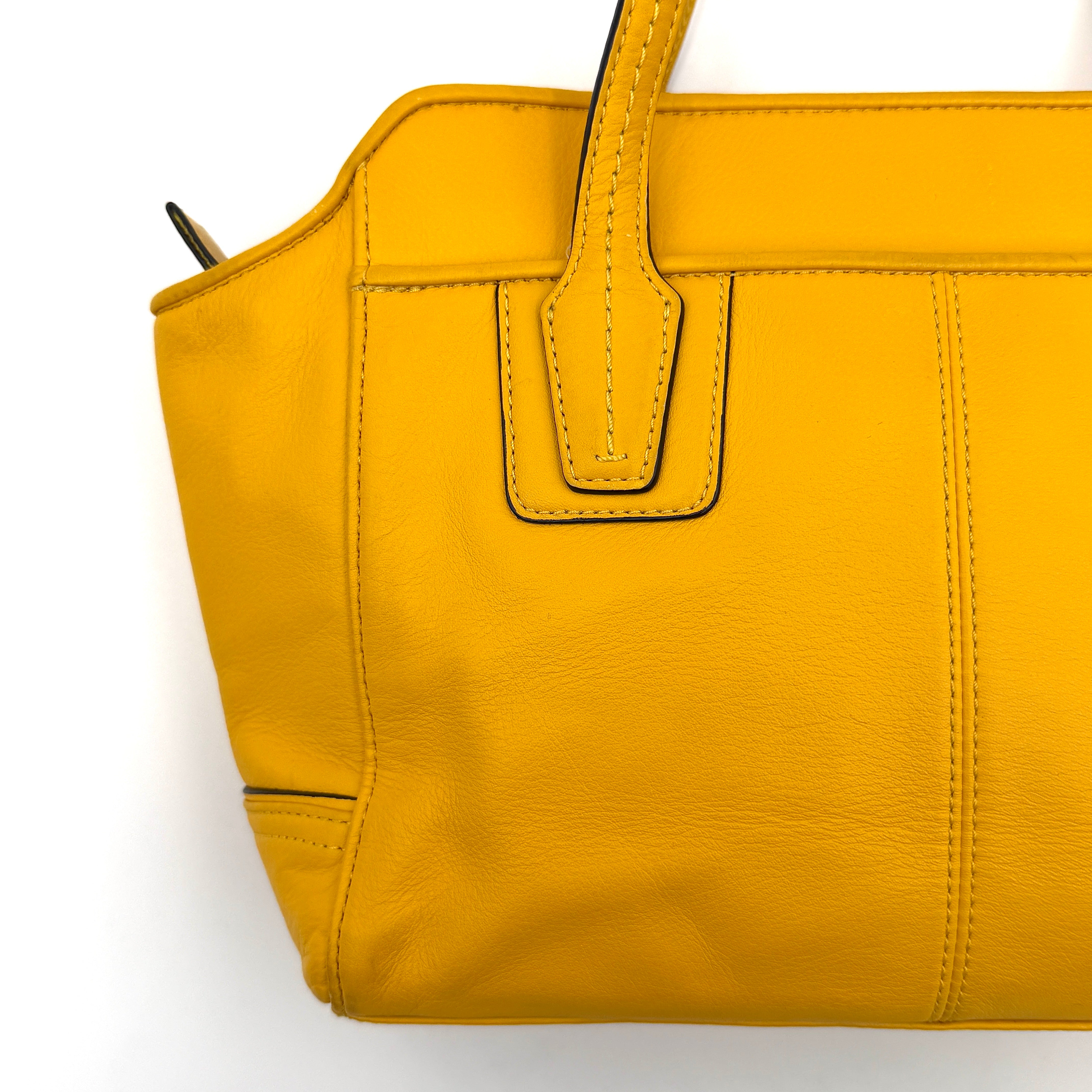 Coach Taylor Bette Mini Tote Bag in vibrant yellow leather with double top handles and detachable shoulder strap displayed beside it.