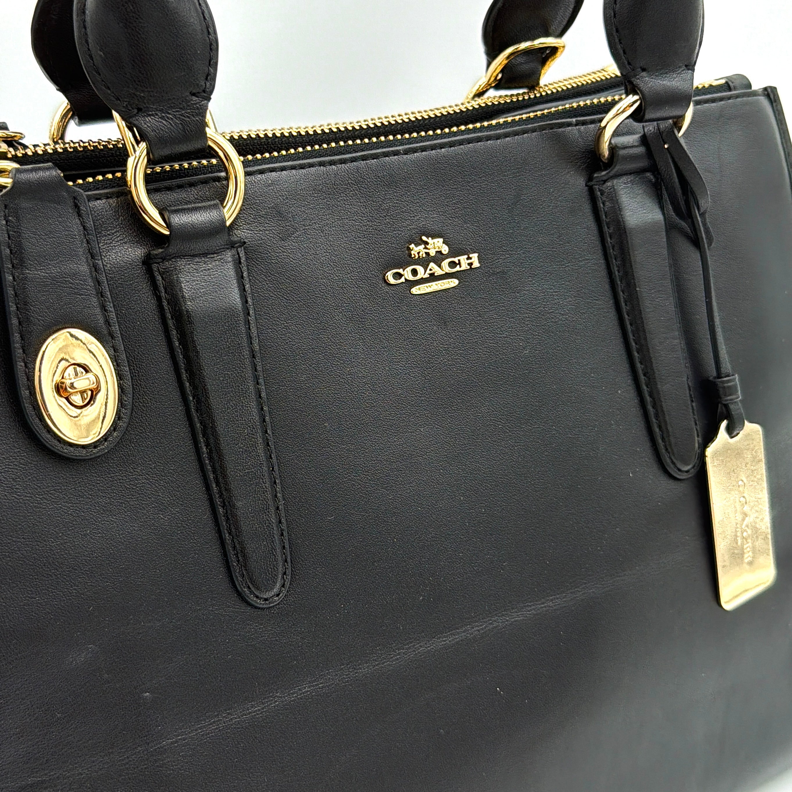 Coach Crosby Carryall Handbag in smooth black leather with gold-tone hardware and a structured silhouette.