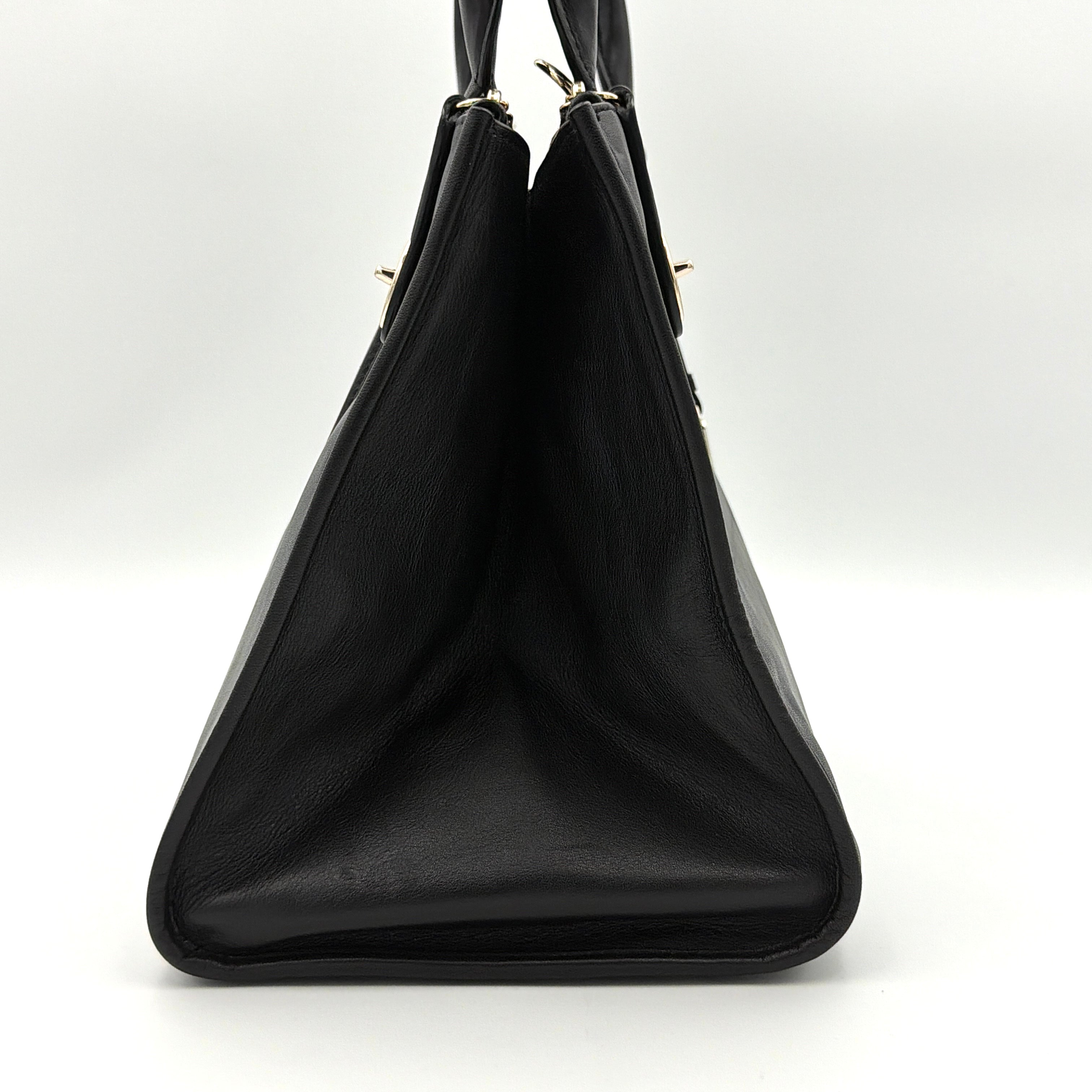 Coach Crosby Carryall Handbag in smooth black leather with gold-tone hardware and a structured silhouette.