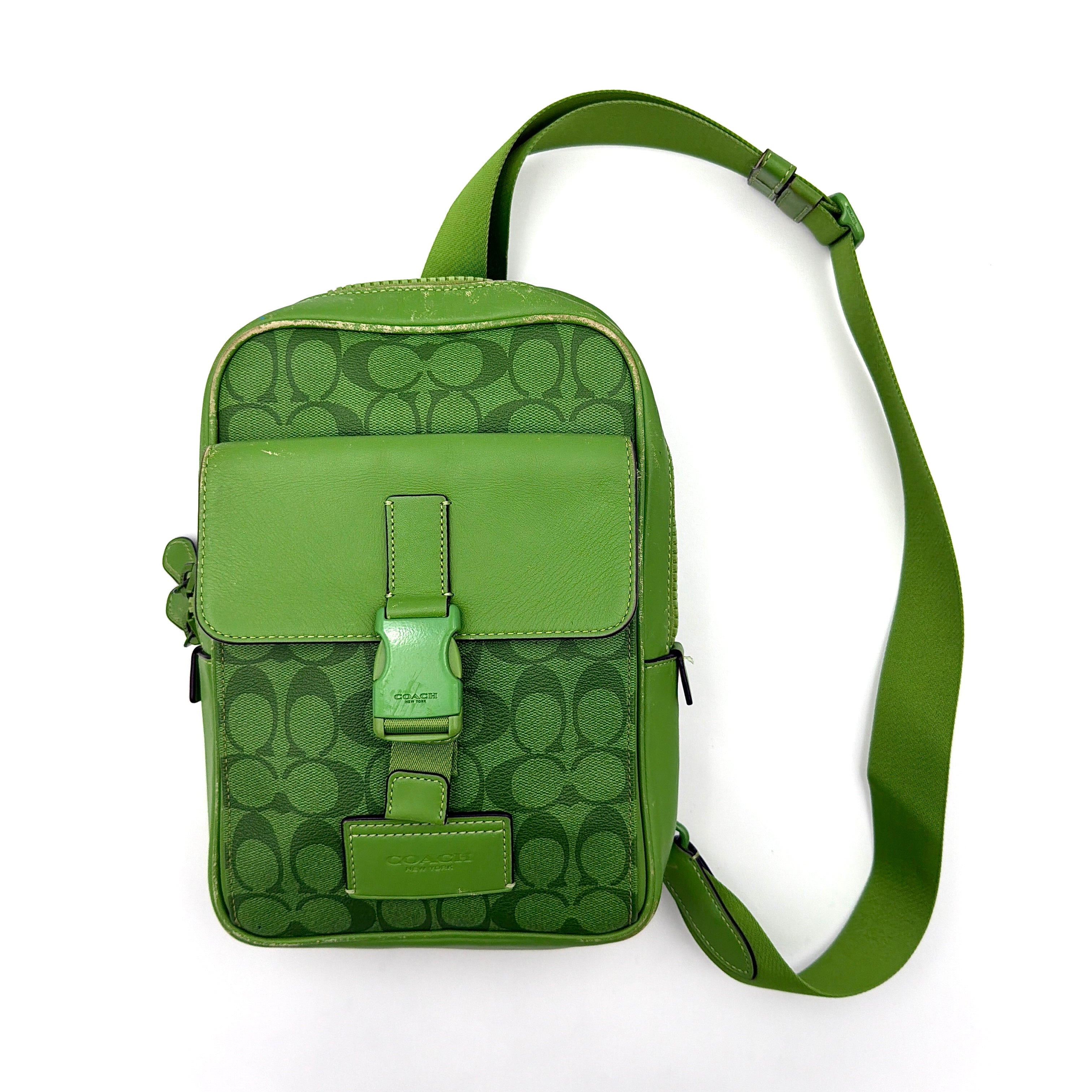 Coach Signature Canvas Track Pack Crossbody Bag in vibrant green with tonal green hardware and adjustable strap set against a clean background.
