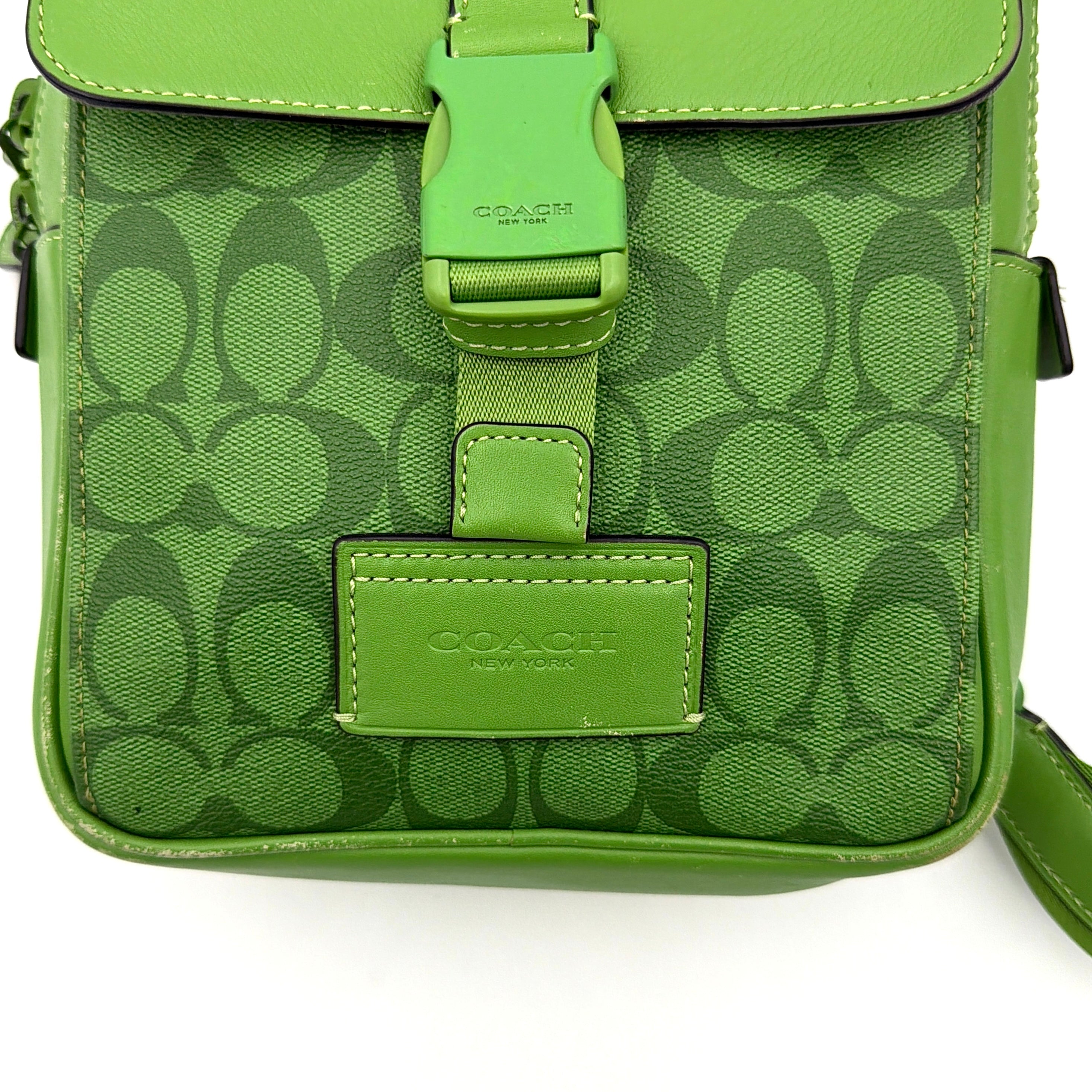 Coach Signature Canvas Track Pack Crossbody Bag in vibrant green with tonal green hardware and adjustable strap set against a clean background.
