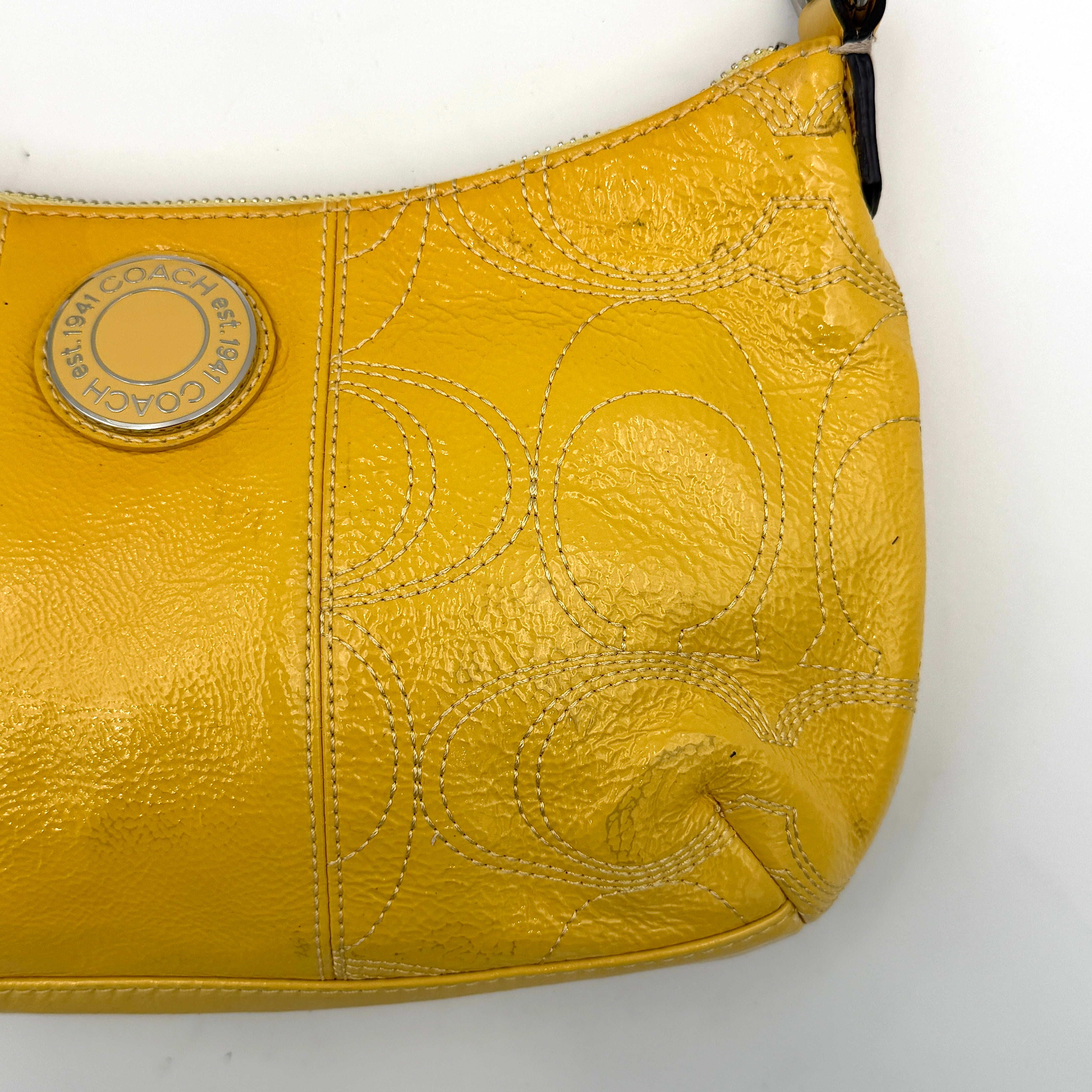 Coach 2Way Signature Stripe Patent Shoulder Bag in patent sunflower yellow leather with signature stitching and detachable strap displayed.