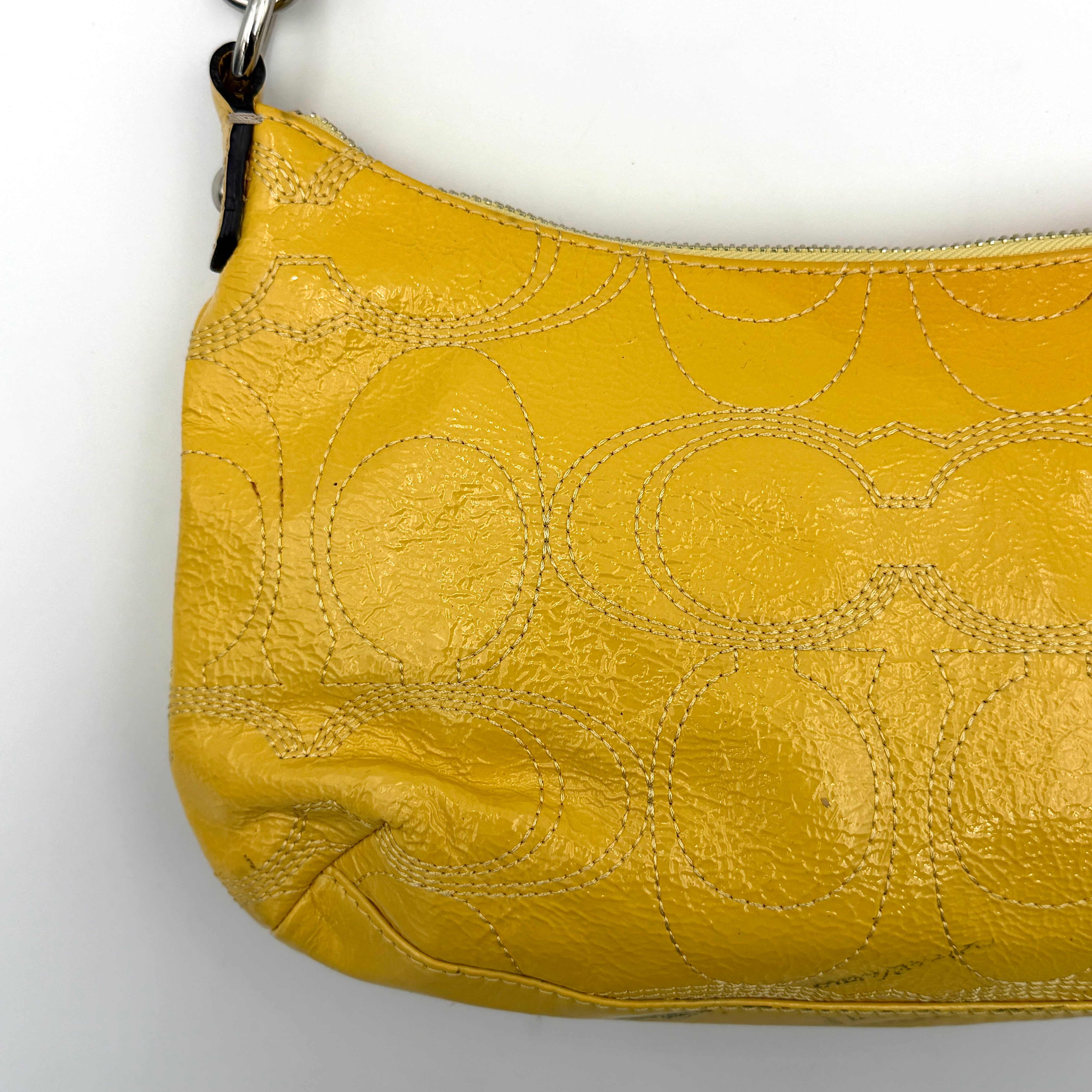 Coach 2Way Signature Stripe Patent Shoulder Bag in patent sunflower yellow leather with signature stitching and detachable strap displayed.