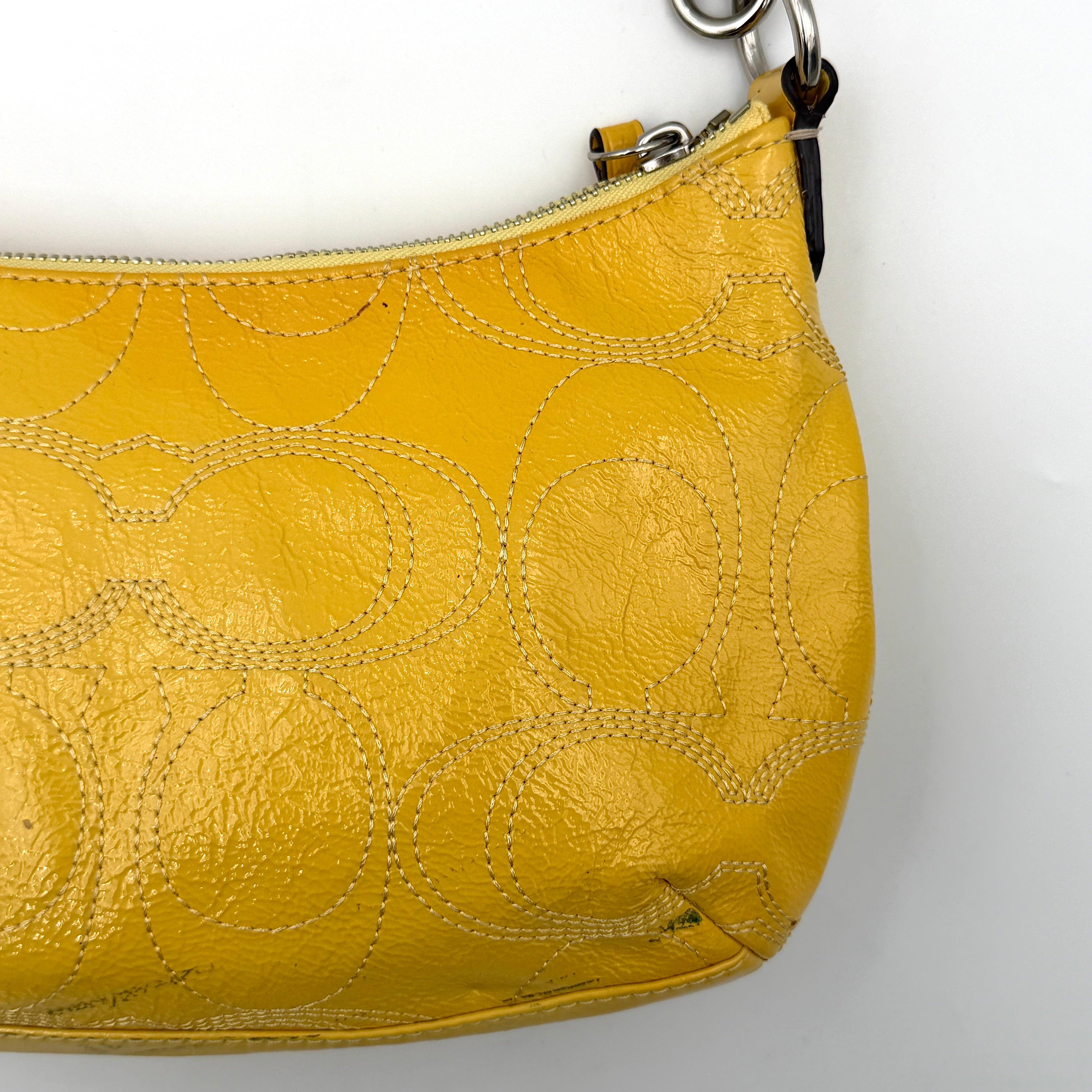 Coach 2Way Signature Stripe Patent Shoulder Bag in patent sunflower yellow leather with signature stitching and detachable strap displayed.