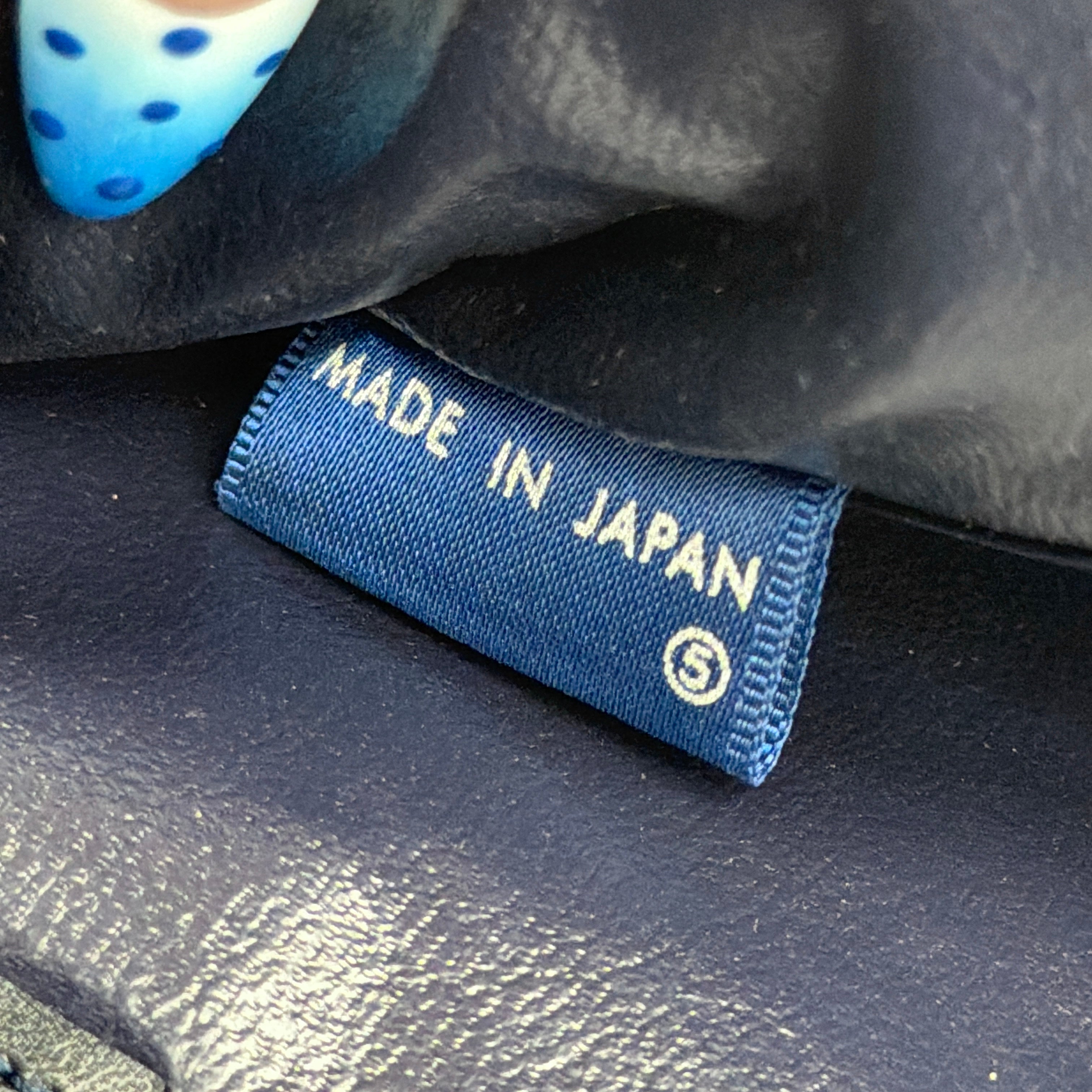 Celine Noevir Macadam Foldover Tote in navy jacquard with carriage motif, leather trim and cutout handles, photographed against a white background.