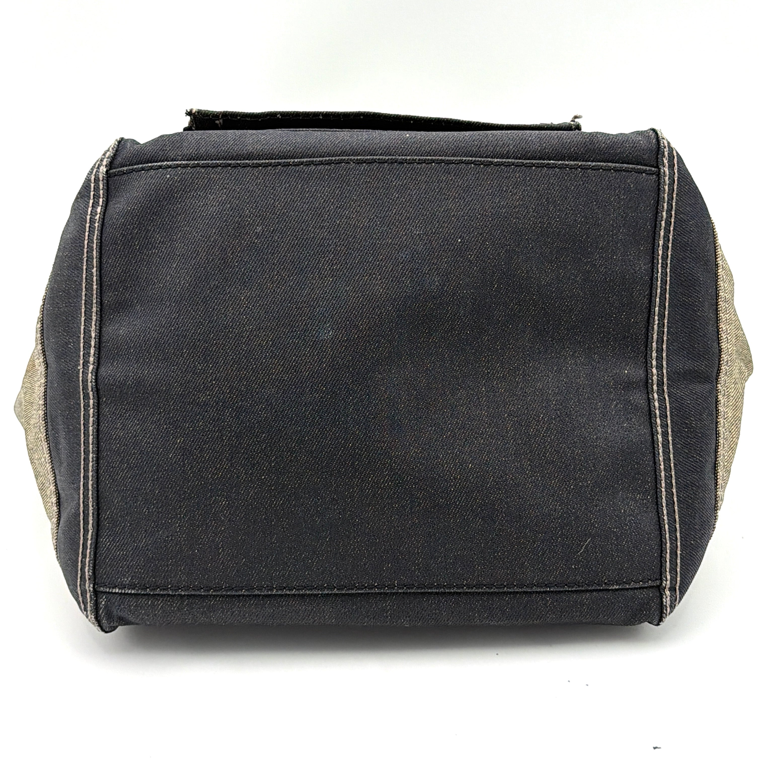 Diesel washed denim shoulder bag with black leather handles, gold zips and frayed edge detail.