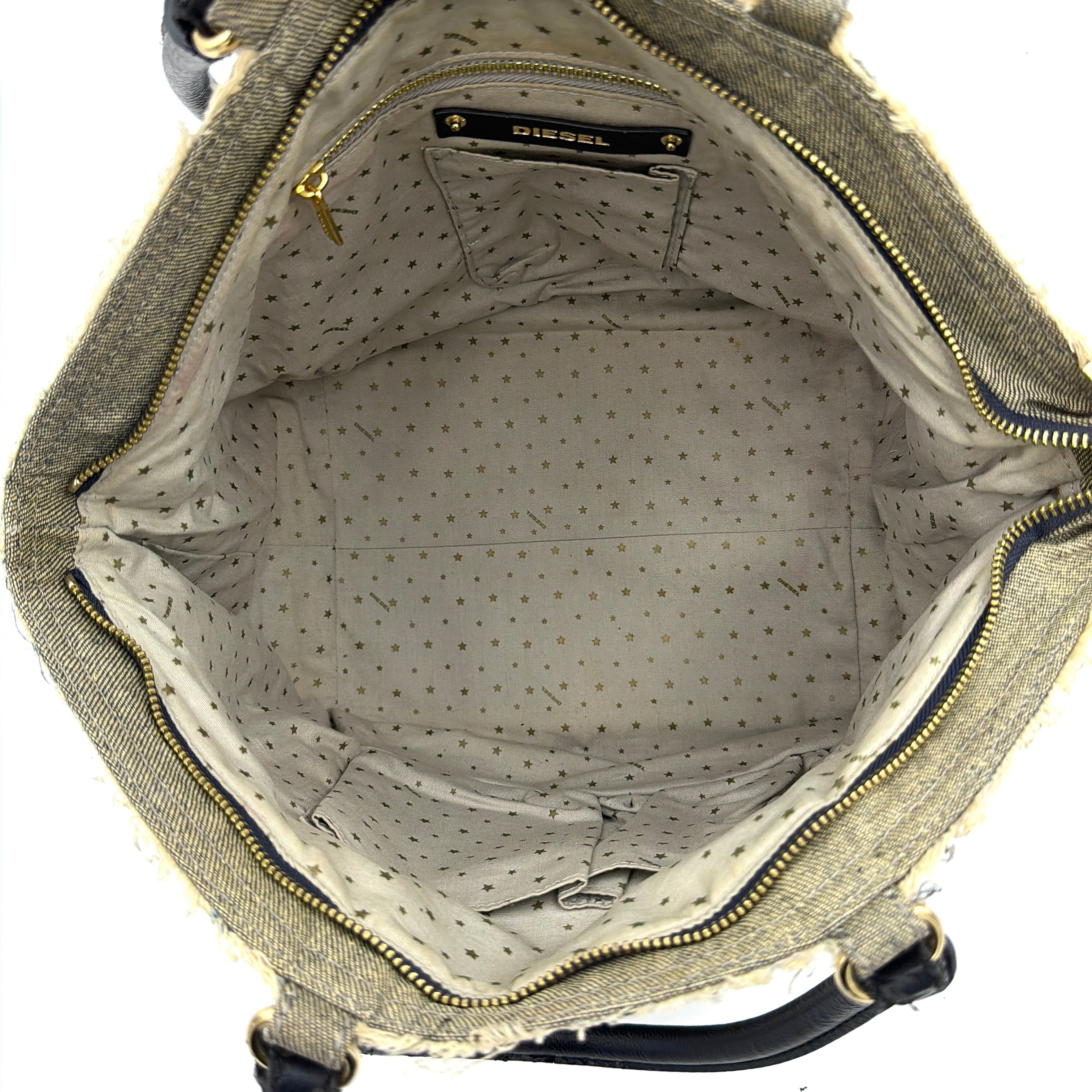 Diesel washed denim shoulder bag with black leather handles, gold zips and frayed edge detail.
