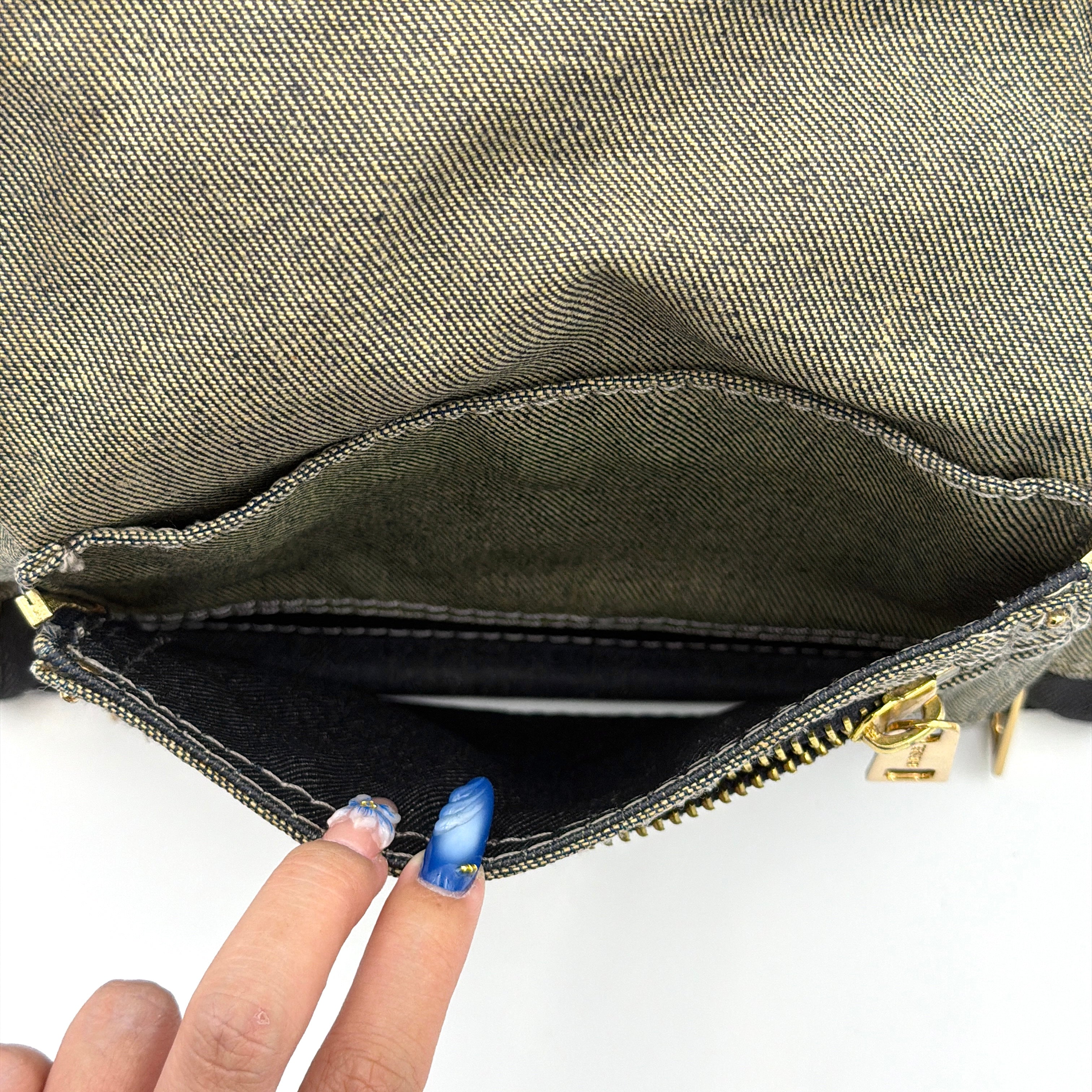 Diesel washed denim shoulder bag with black leather handles, gold zips and frayed edge detail.