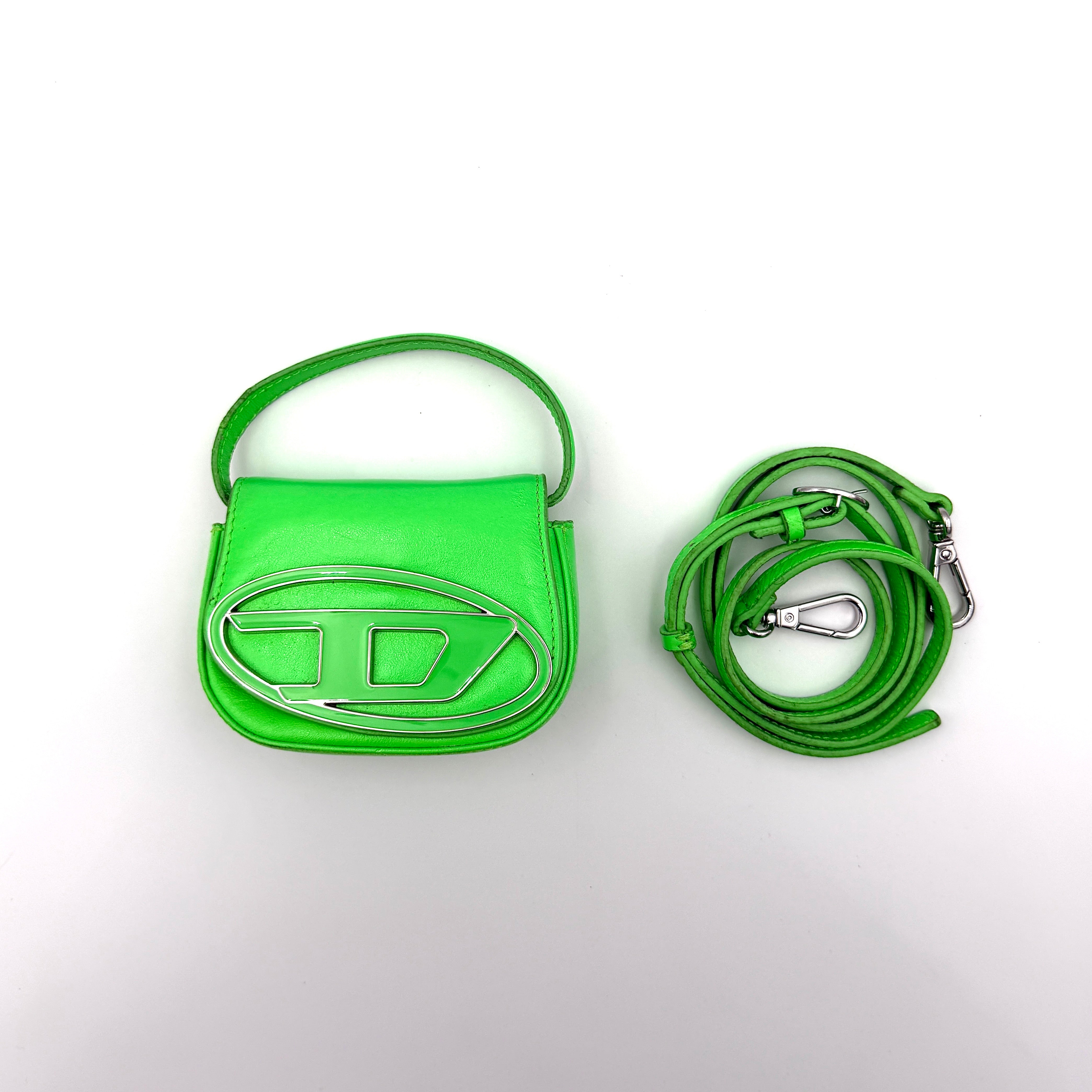 Diesel 1DR-XS Mini Bag in vivid neon green leather with bold silver D plaque and detachable strap, presented against a clean background.