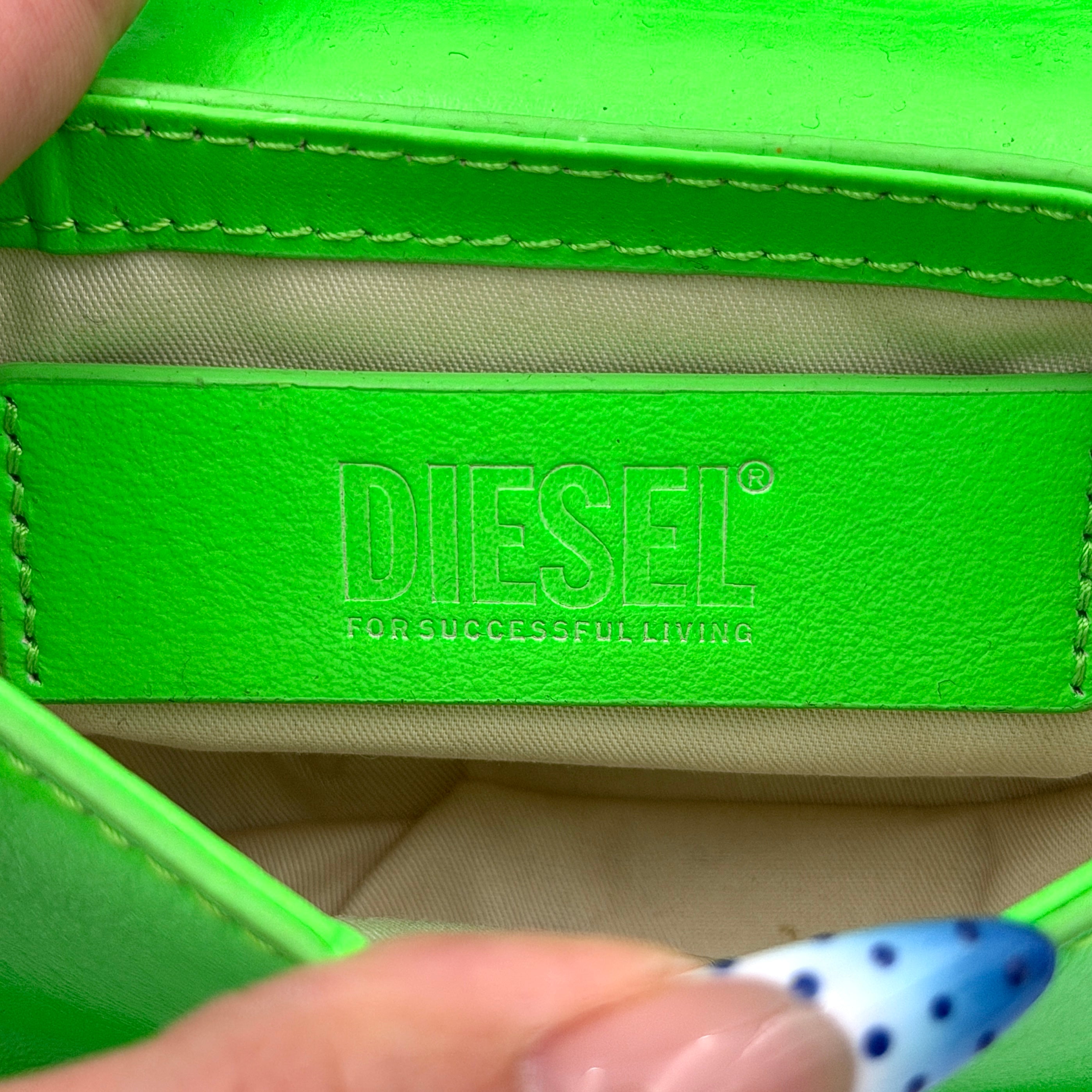 Diesel 1DR-XS Mini Bag in vivid neon green leather with bold silver D plaque and detachable strap, presented against a clean background.