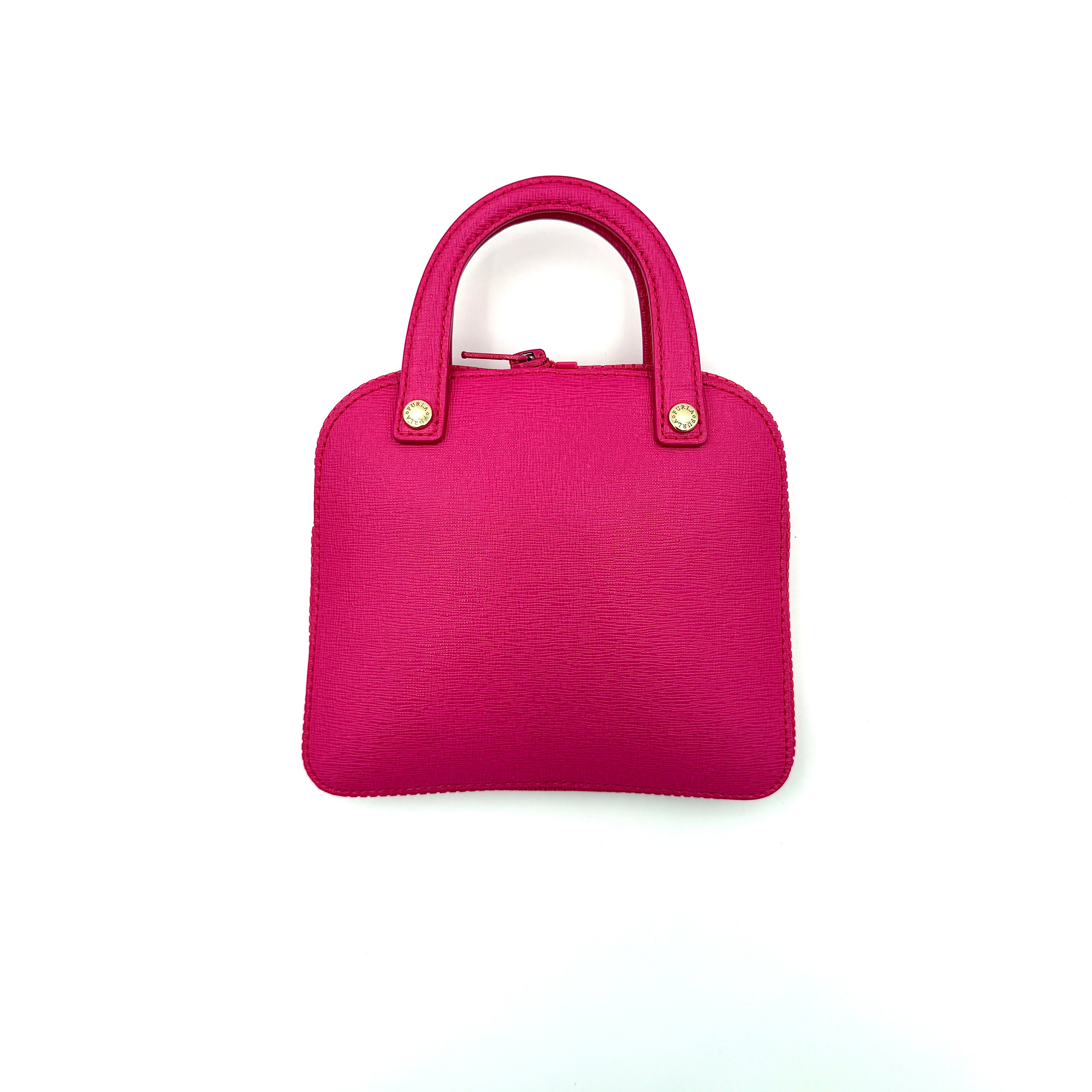 Furla black nylon tote bag with a bold pink zip pouch detail, styled as an exterior pocket, displayed flat to showcase its silhouette.
