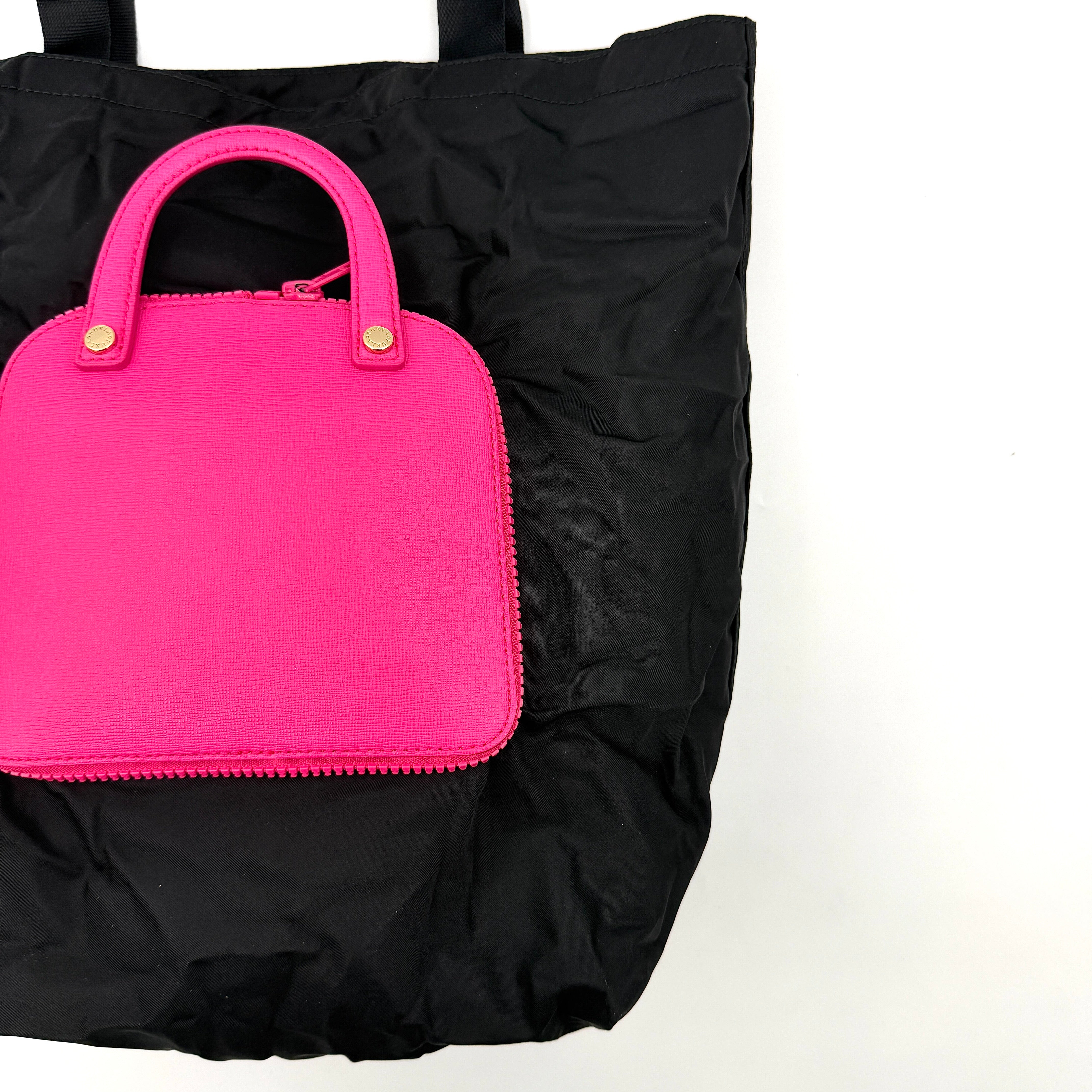 Furla black nylon tote bag with a bold pink zip pouch detail, styled as an exterior pocket, displayed flat to showcase its silhouette.