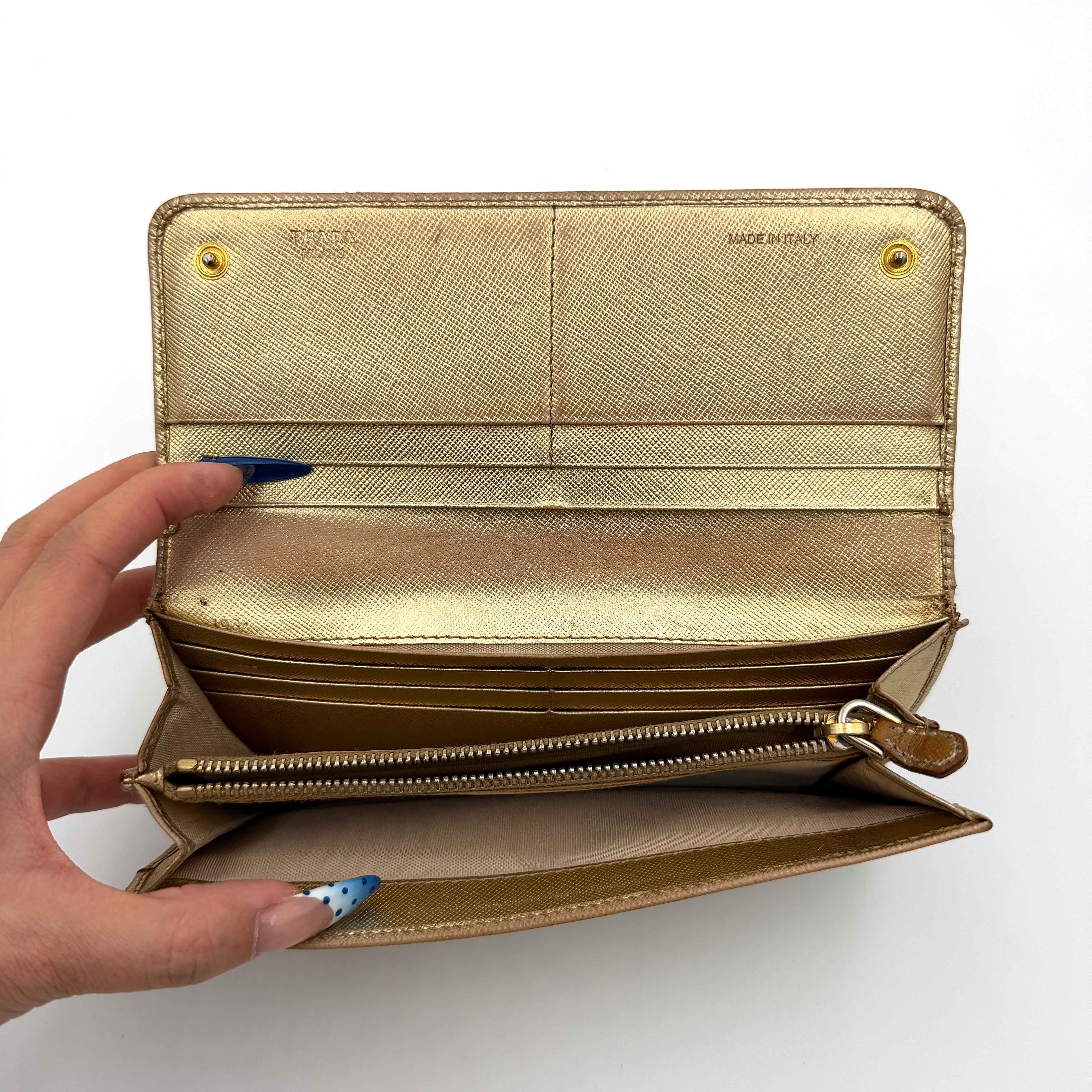 Prada Saffiano Continental Long Wallet in metallic gold Saffiano leather with gold-tone logo and structured silhouette.