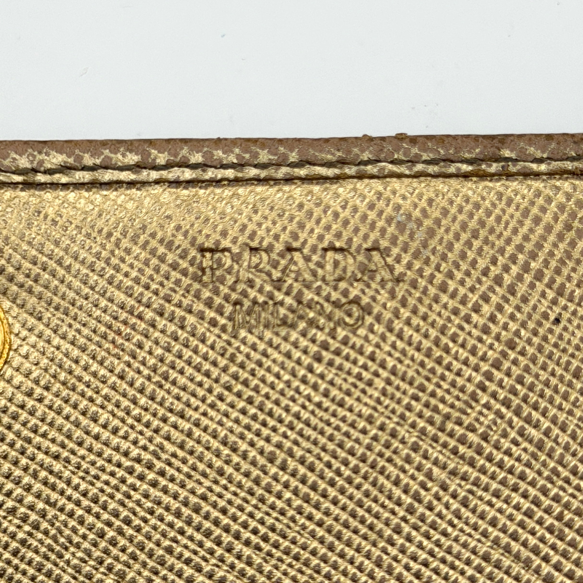 Prada Saffiano Continental Long Wallet in metallic gold Saffiano leather with gold-tone logo and structured silhouette.