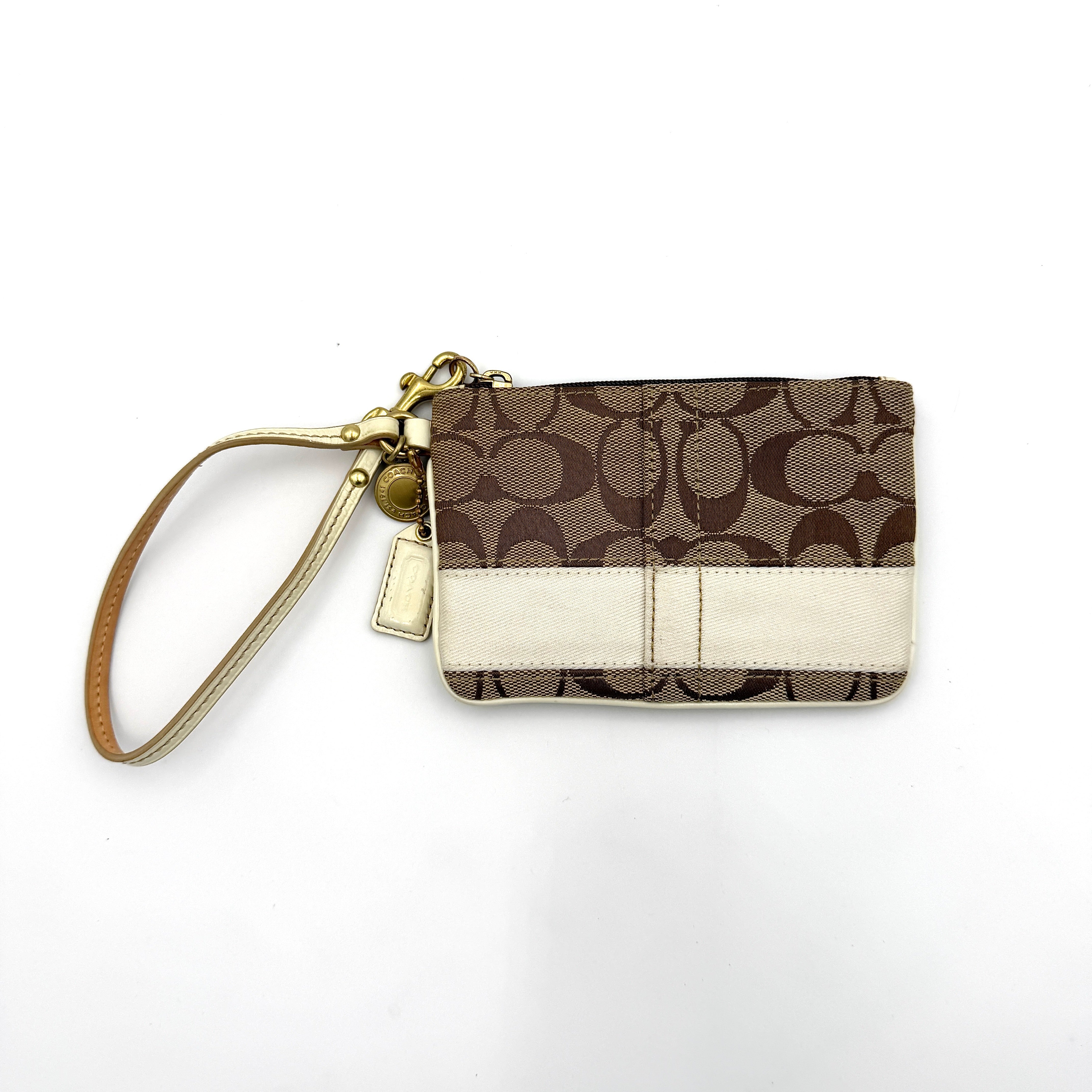 Coach Signature Stripe Wristlet in beige and cream jacquard, accented with a cream leather strap and gold-tone hardware.
