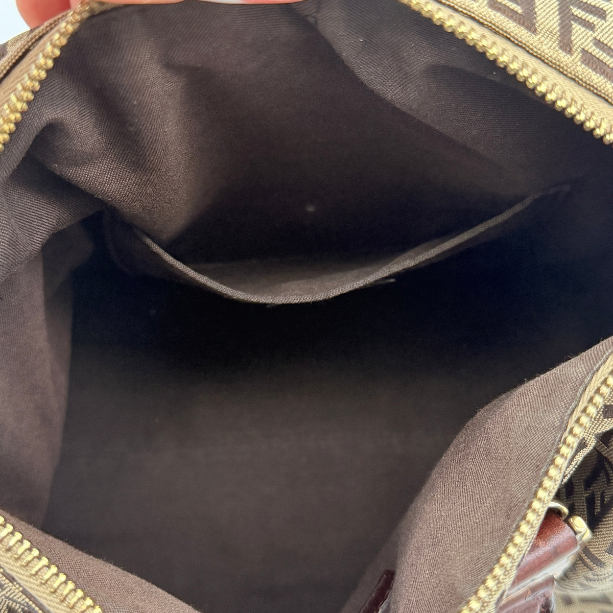 Fendi FF Zucchino Boston bag in brown monogram canvas with mahogany leather trim and gold hardware, photographed against a white background.