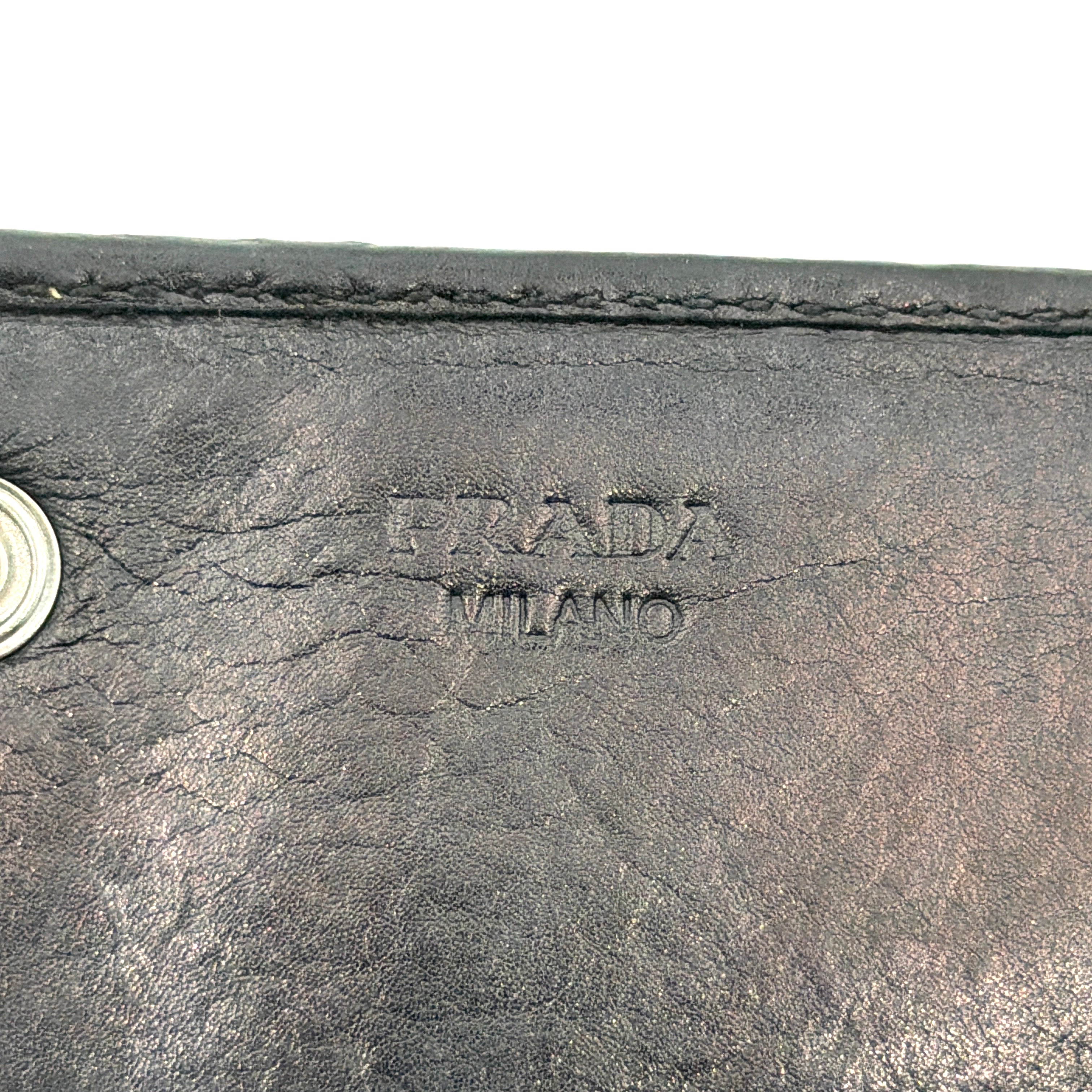Prada Fiocco Bow Continental Wallet in black leather with a central grosgrain bow and silver-tone accents, displayed with refined simplicity.