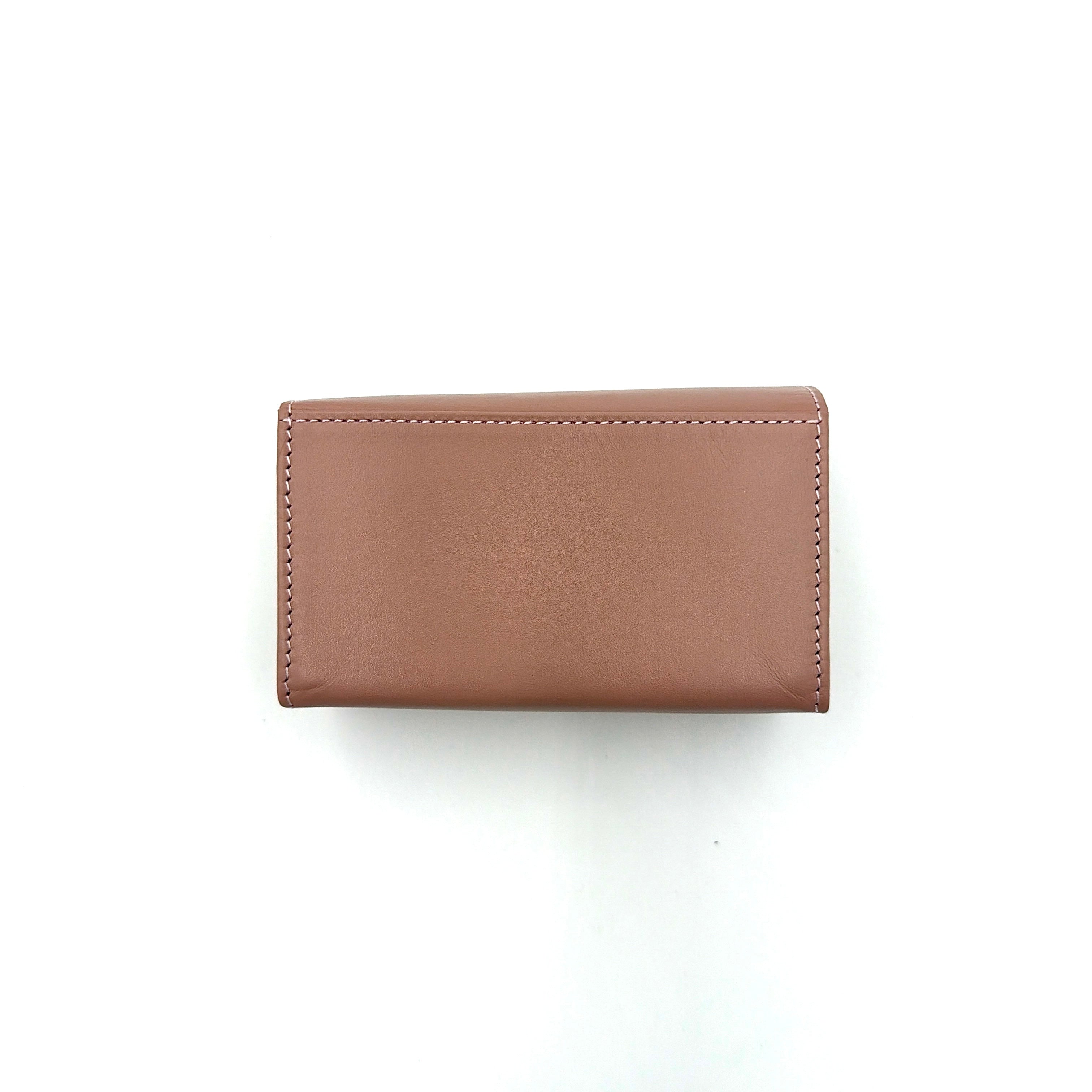 Vivienne Westwood pink leather wallet with silver signature Orb hardware, styled against a clean background.