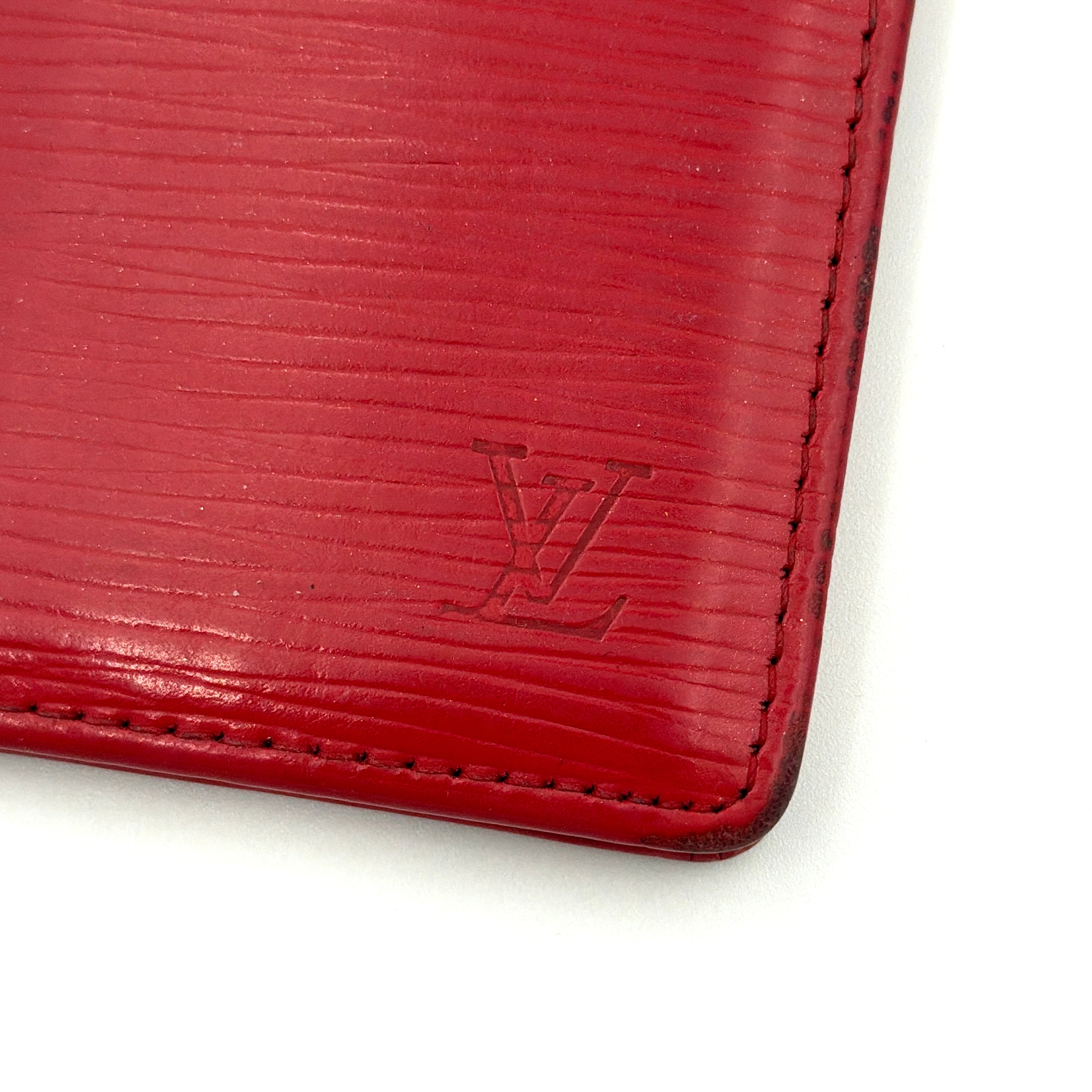 Front-facing view of the Louis Vuitton Epi Leather Pocket Organizer in a striking red, featuring subtle LV embossing and an elegant textured finish.