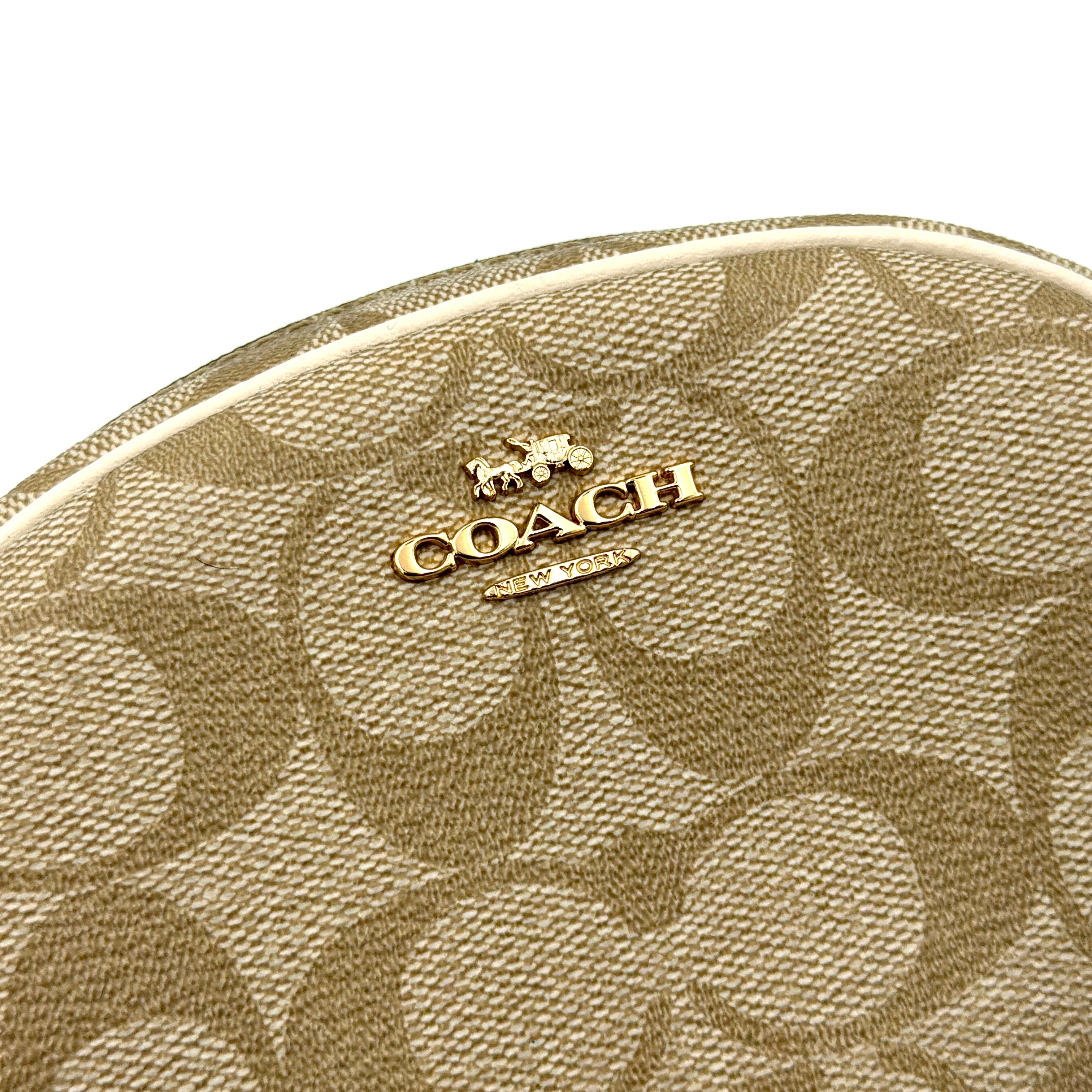 Coach Signature Canvas Dome Cosmetic Case in beige monogram canvas with gold hardware and curved silhouette.