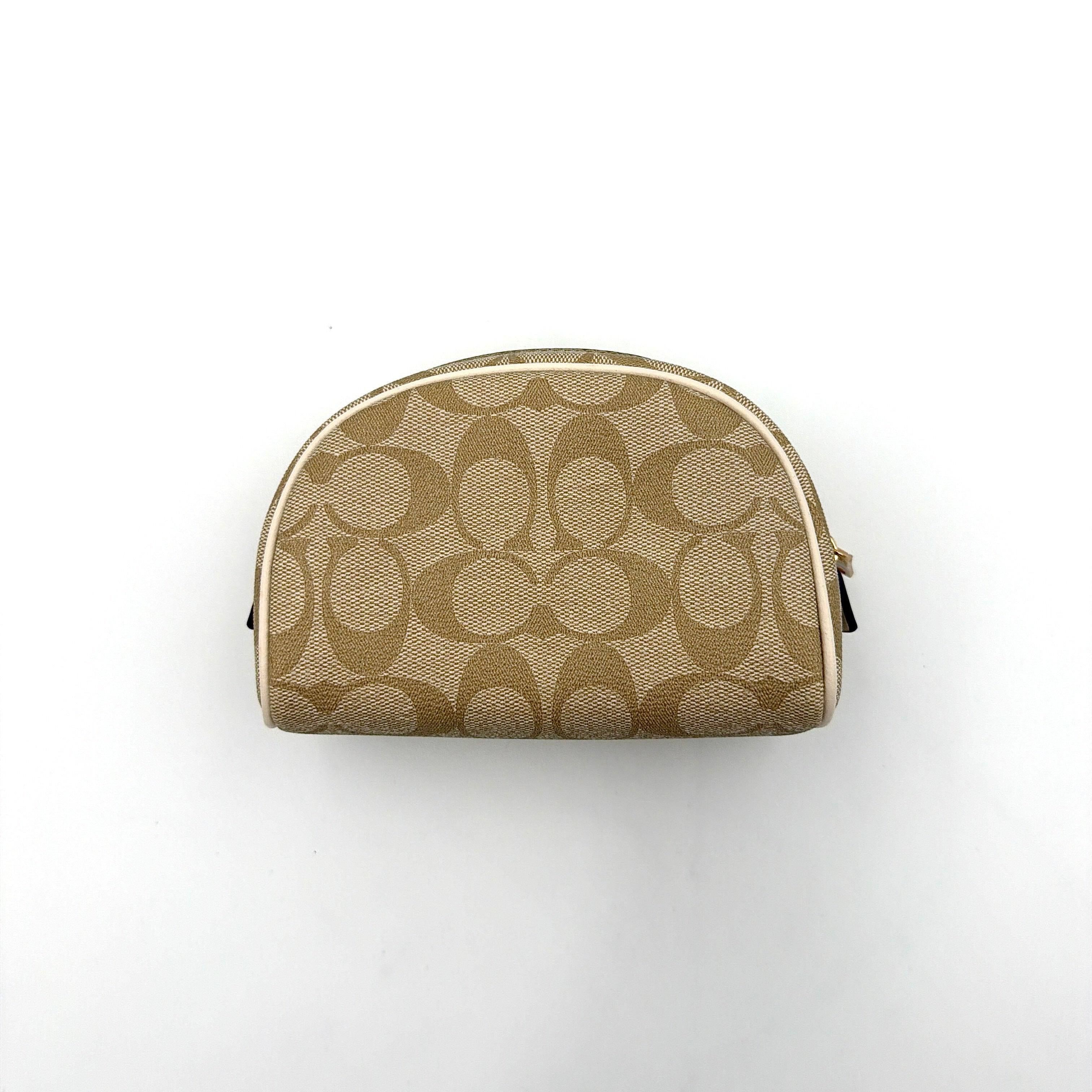 Coach Signature Canvas Dome Cosmetic Case in beige monogram canvas with gold hardware and curved silhouette.