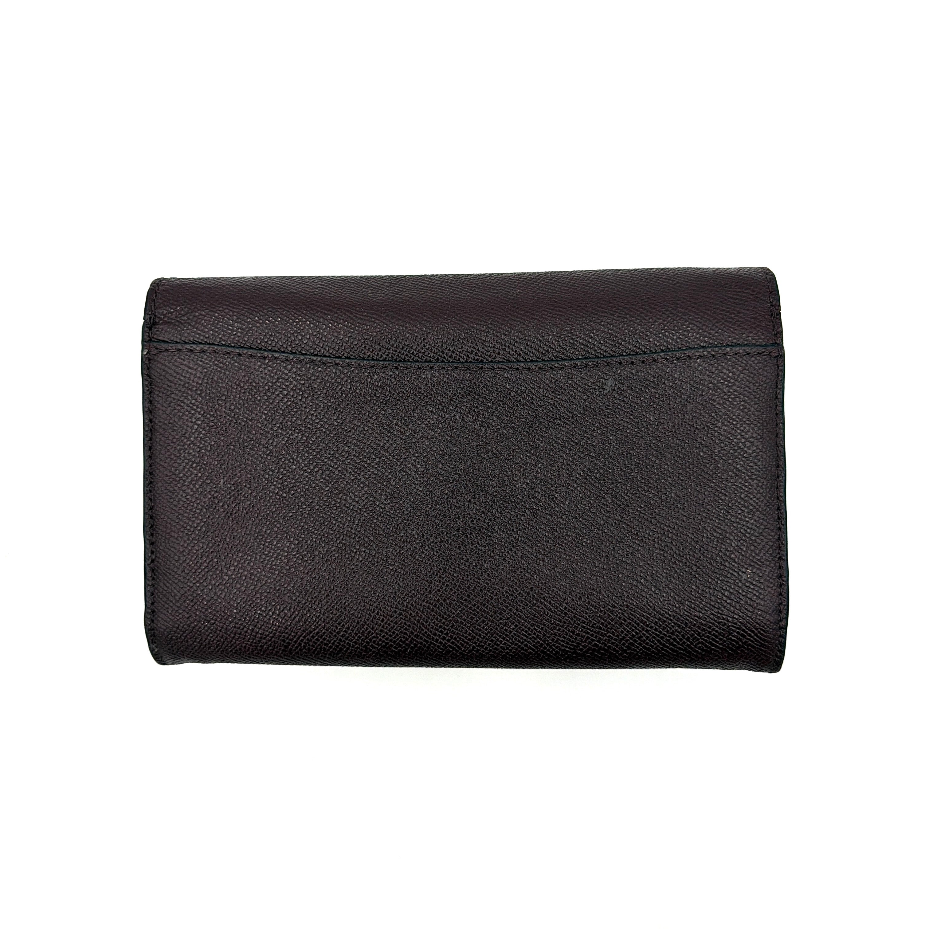 Coach Bear Turnlock Clutch in burgundy leather with playful pink and silver star details and signature gunmetal turnlock front closure.