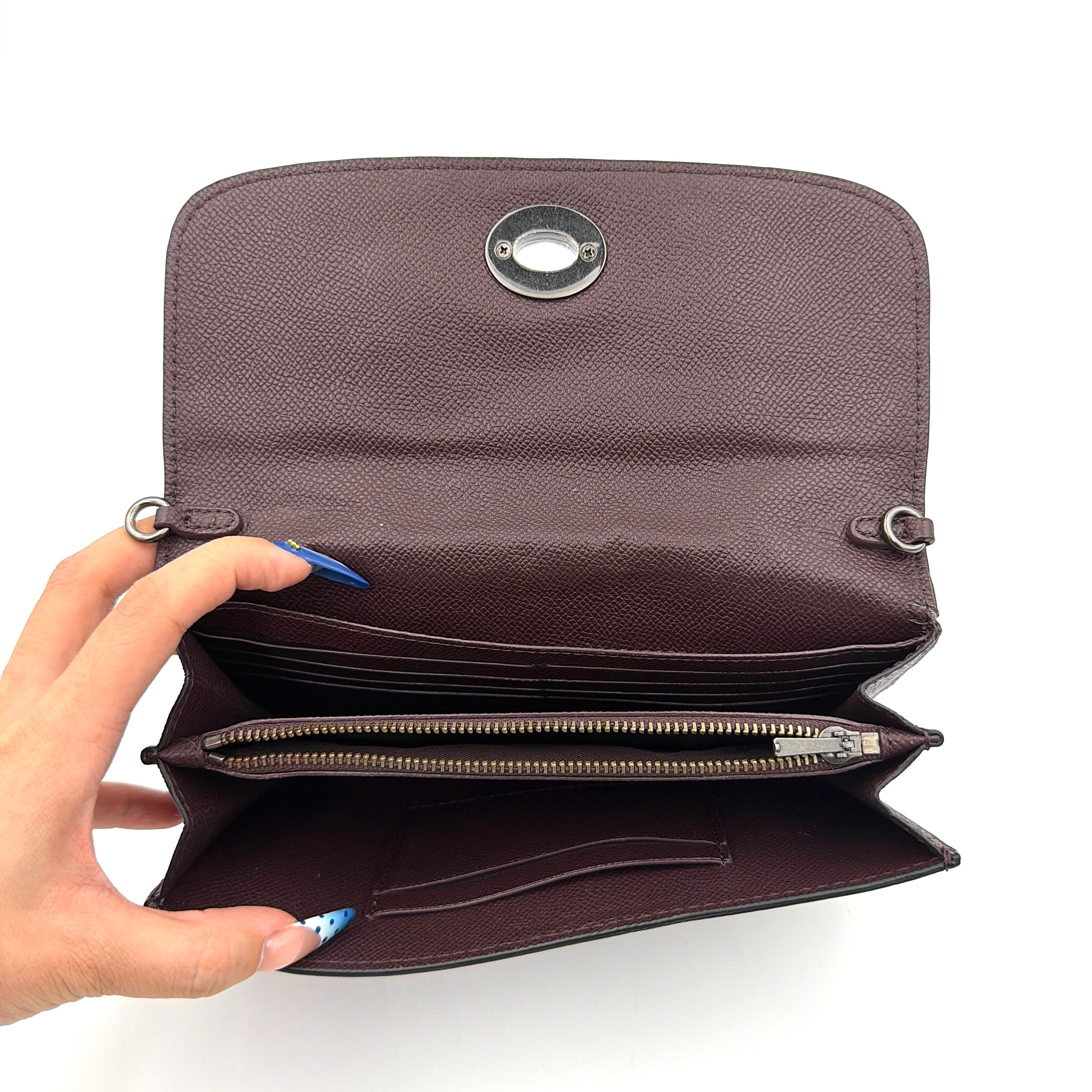 Coach Bear Turnlock Clutch in burgundy leather with playful pink and silver star details and signature gunmetal turnlock front closure.