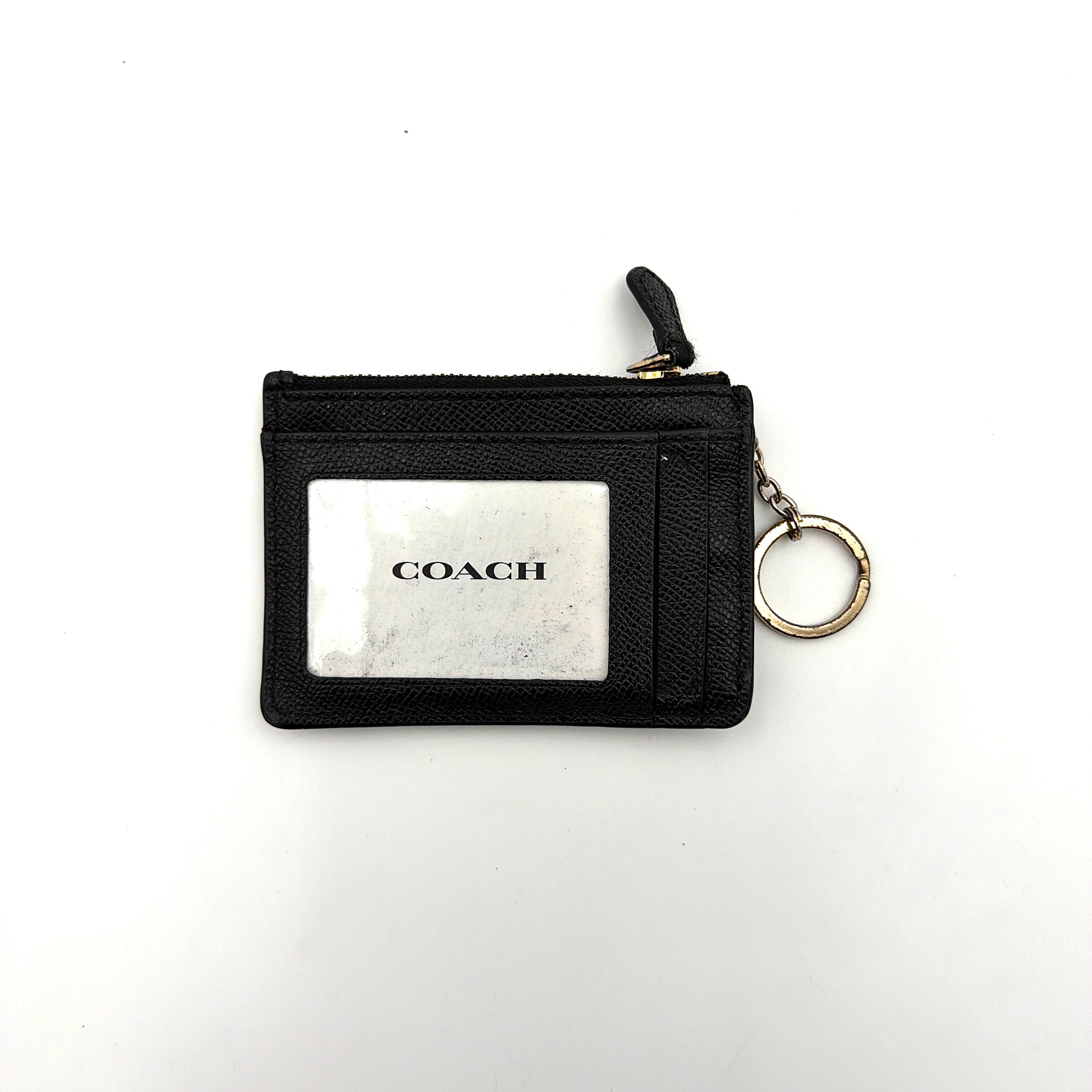Coach Mini Skinny ID Case Cardholder in black leather with gold-tone hardware, featuring a zip closure and signature logo detailing.