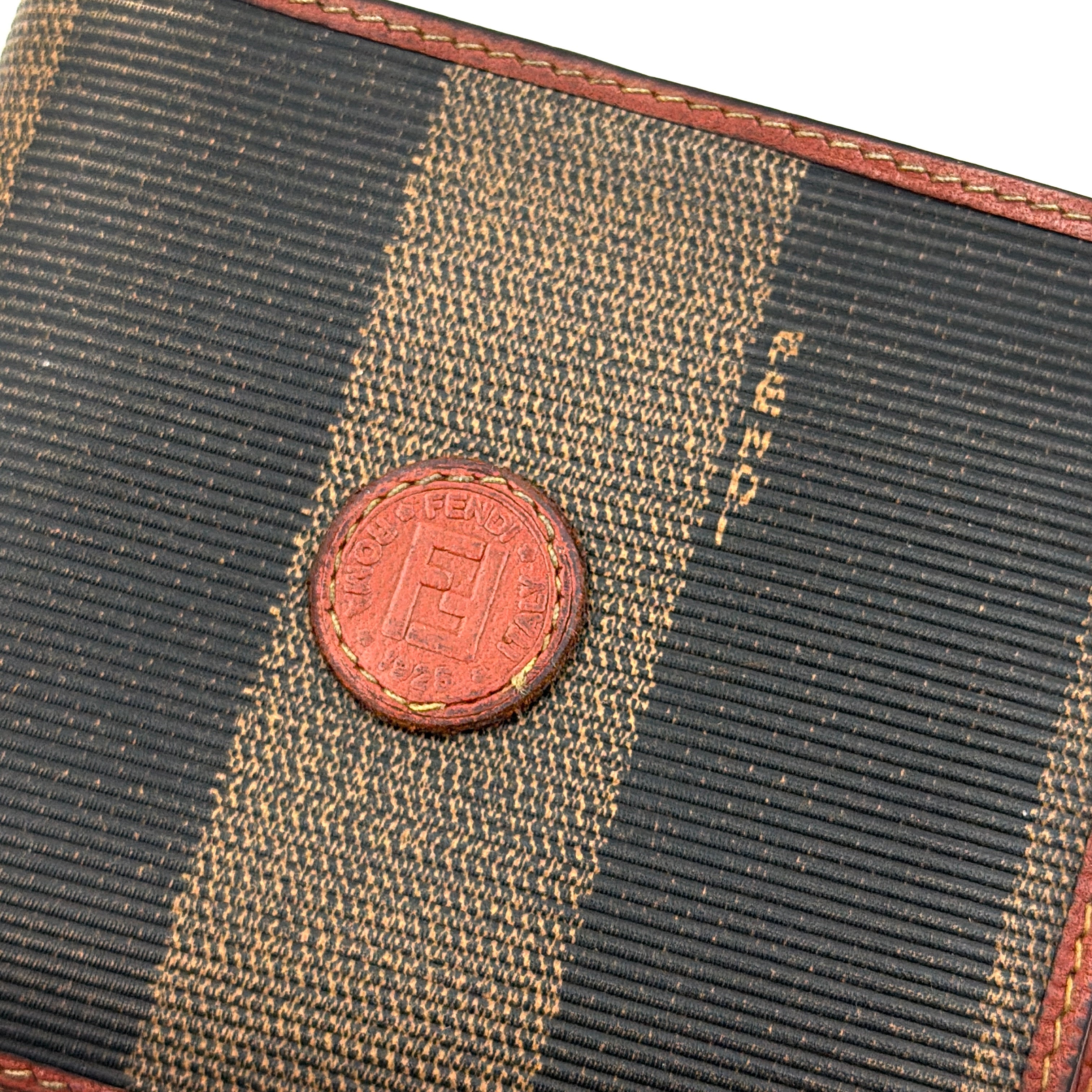 Fendi Pequin Stripe wallet in brown and black canvas with cognac leather trim and circular Fendi badge on the front.