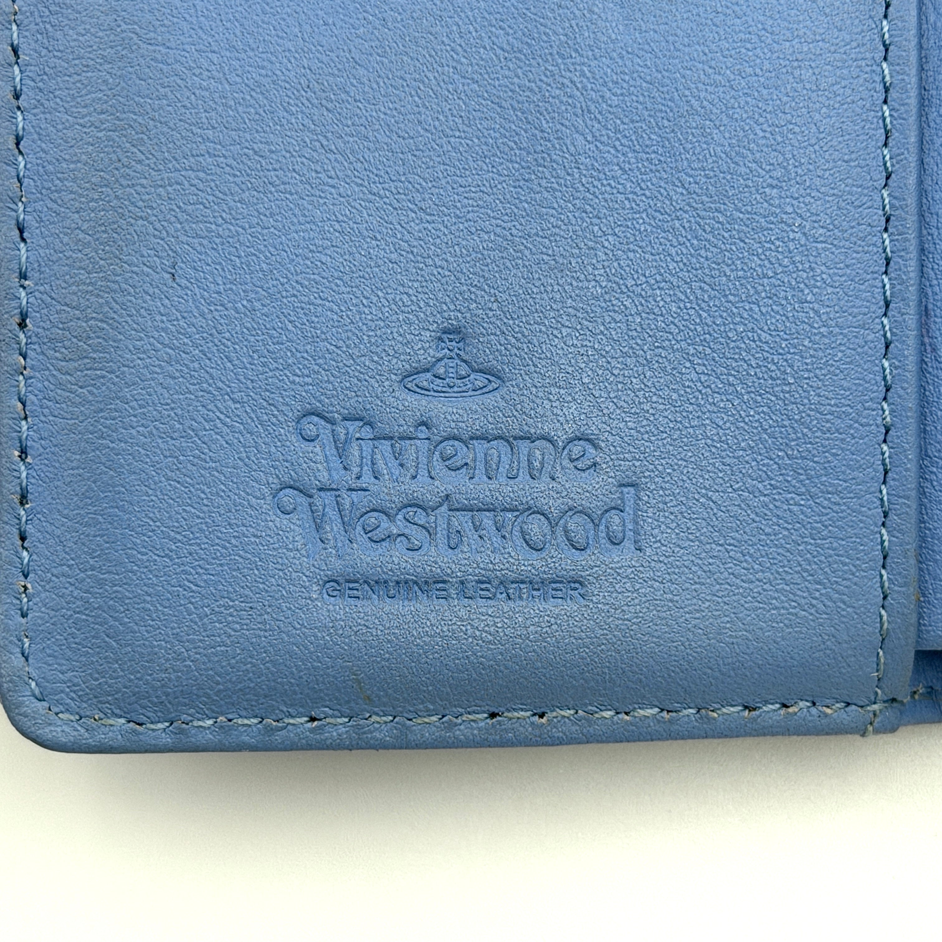A baby blue leather Vivienne Westwood wallet with silver Orb logo and structured silhouette, photographed against a clean background.