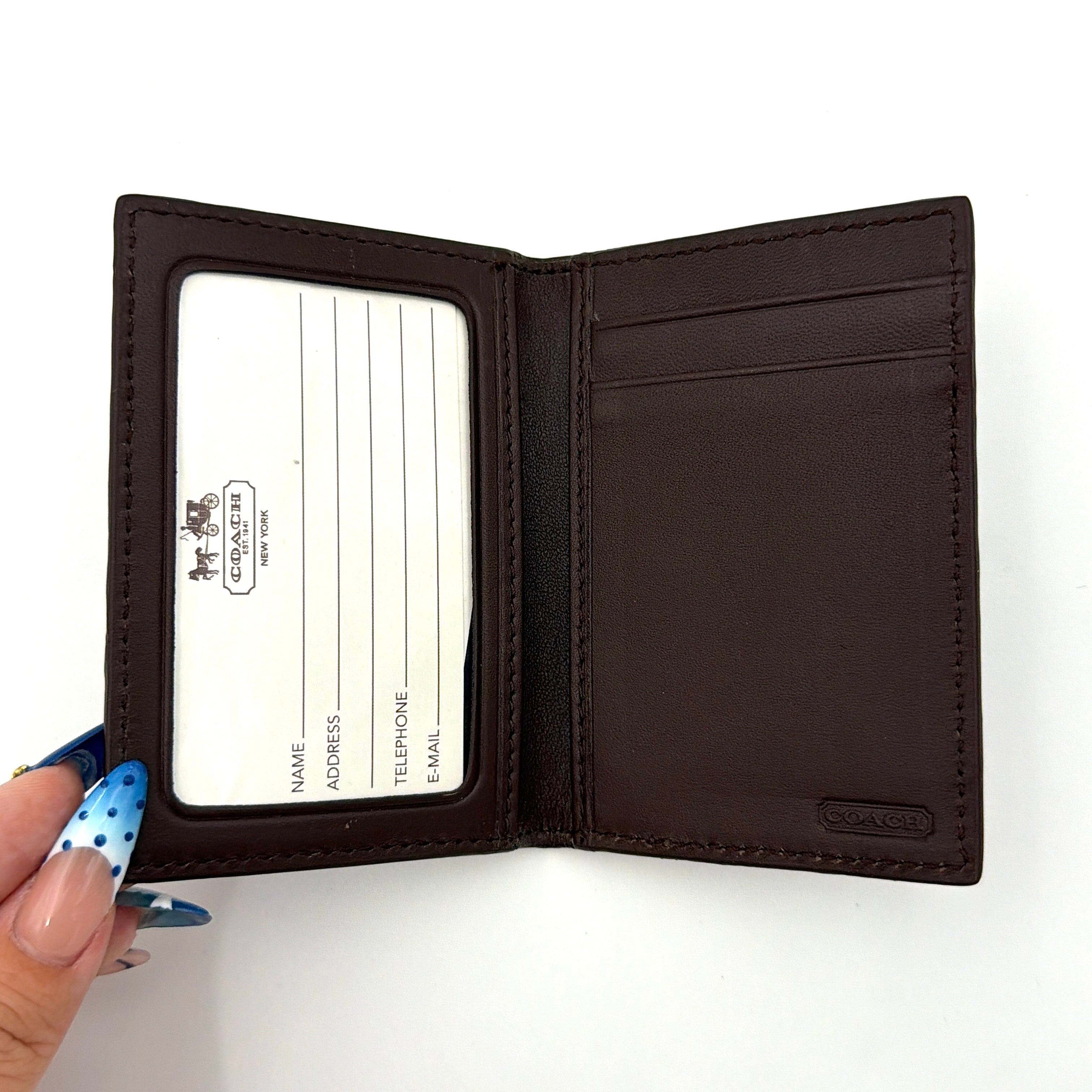 Coach Camden Slim Card Holder in burgundy pebbled leather with embossed logo and sleek bifold silhouette.