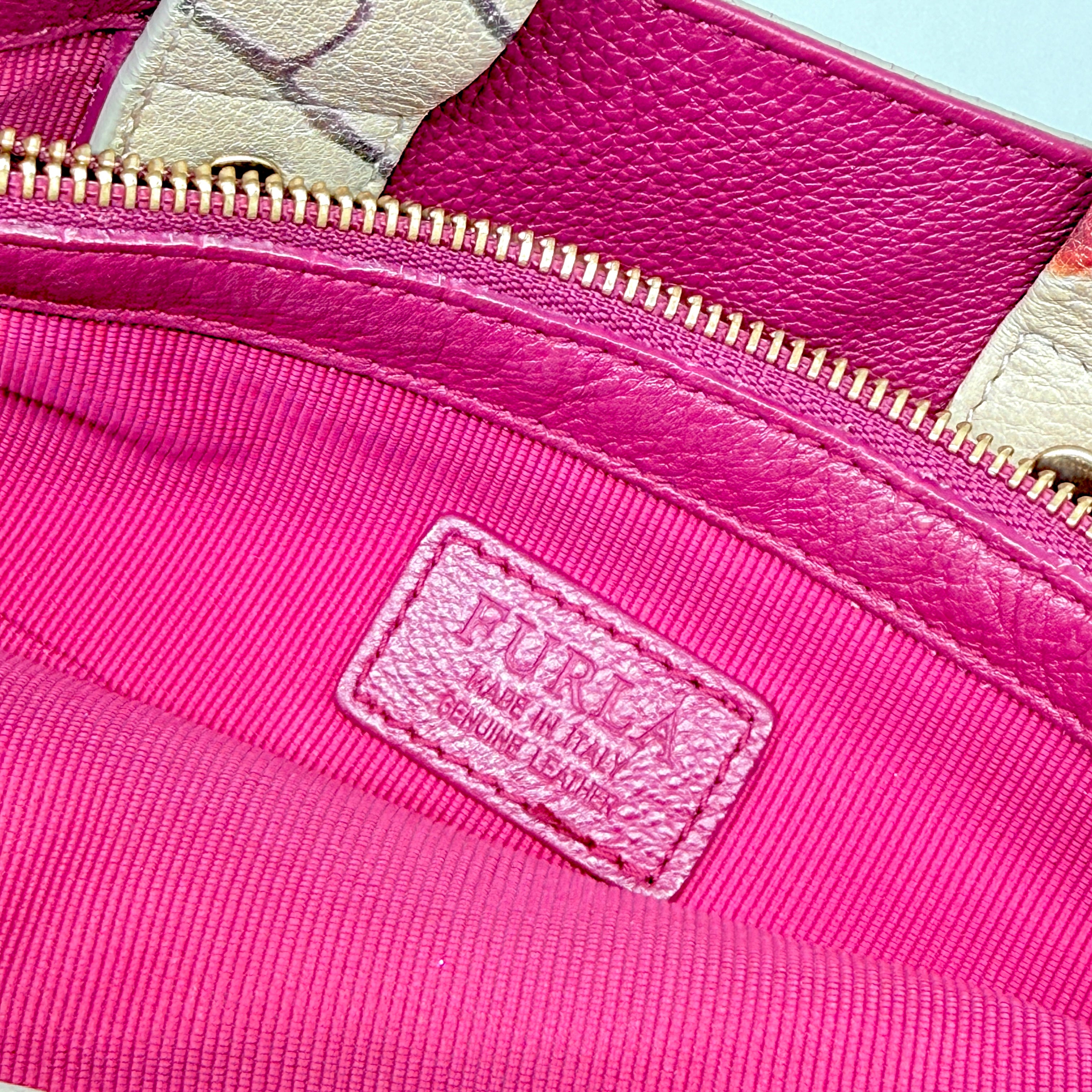 Furla beige leather tote bag adorned with a bold magenta and plum floral print, featuring structured short handles.