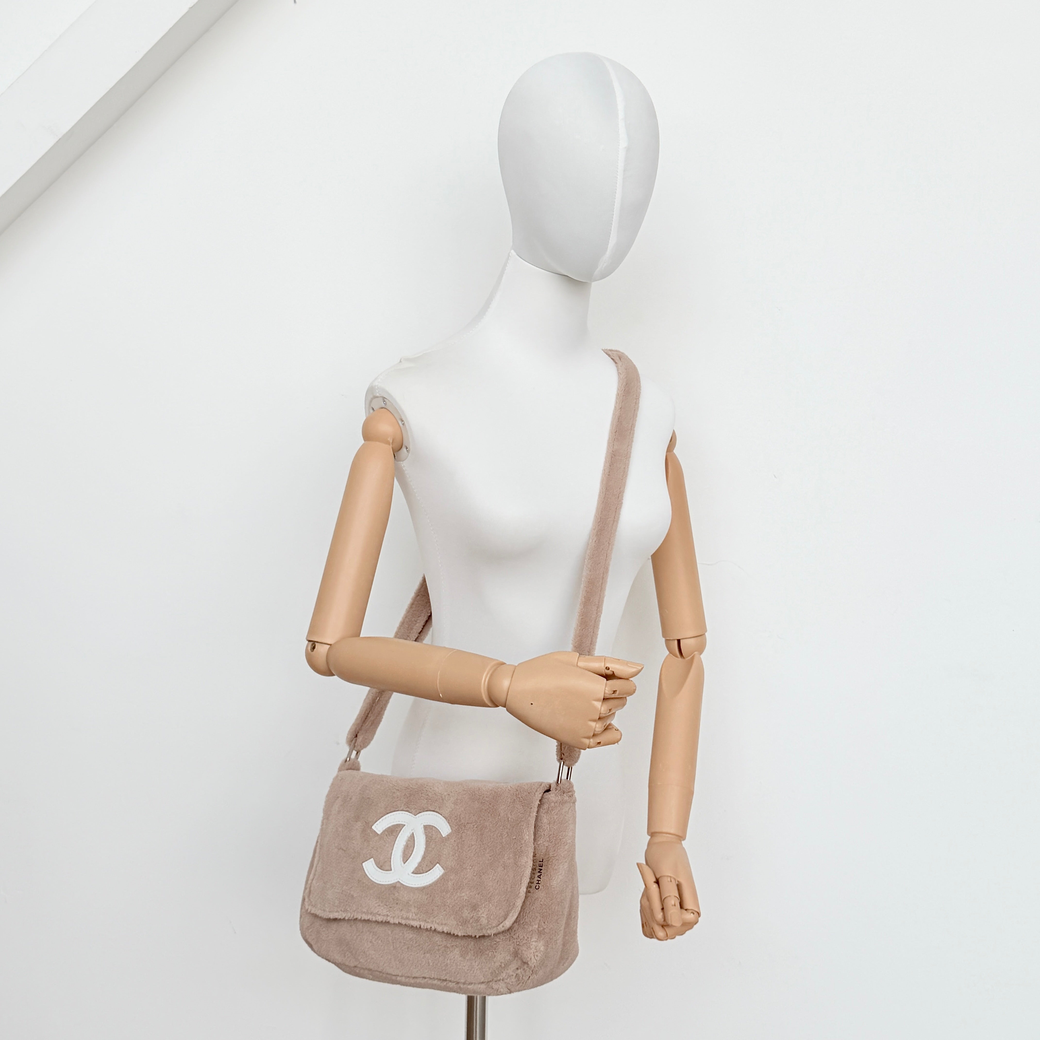 Chanel CC Precision Fragrance Line crossbody bag in beige terry cloth with white logo, shown with long strap.