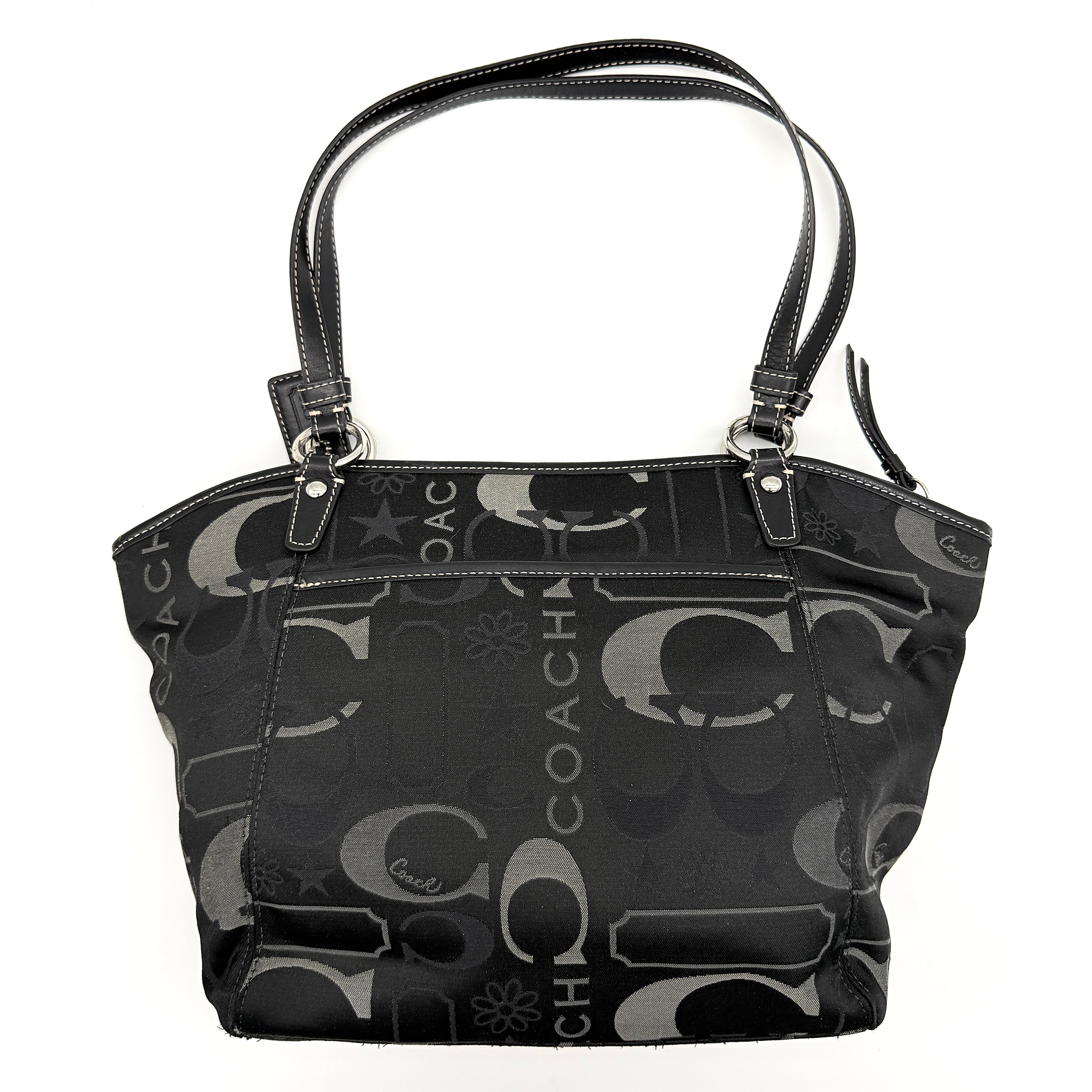 Coach Signature Leah Shoulder Bag in black jacquard with silver-tone hardware and bold logo pattern.
