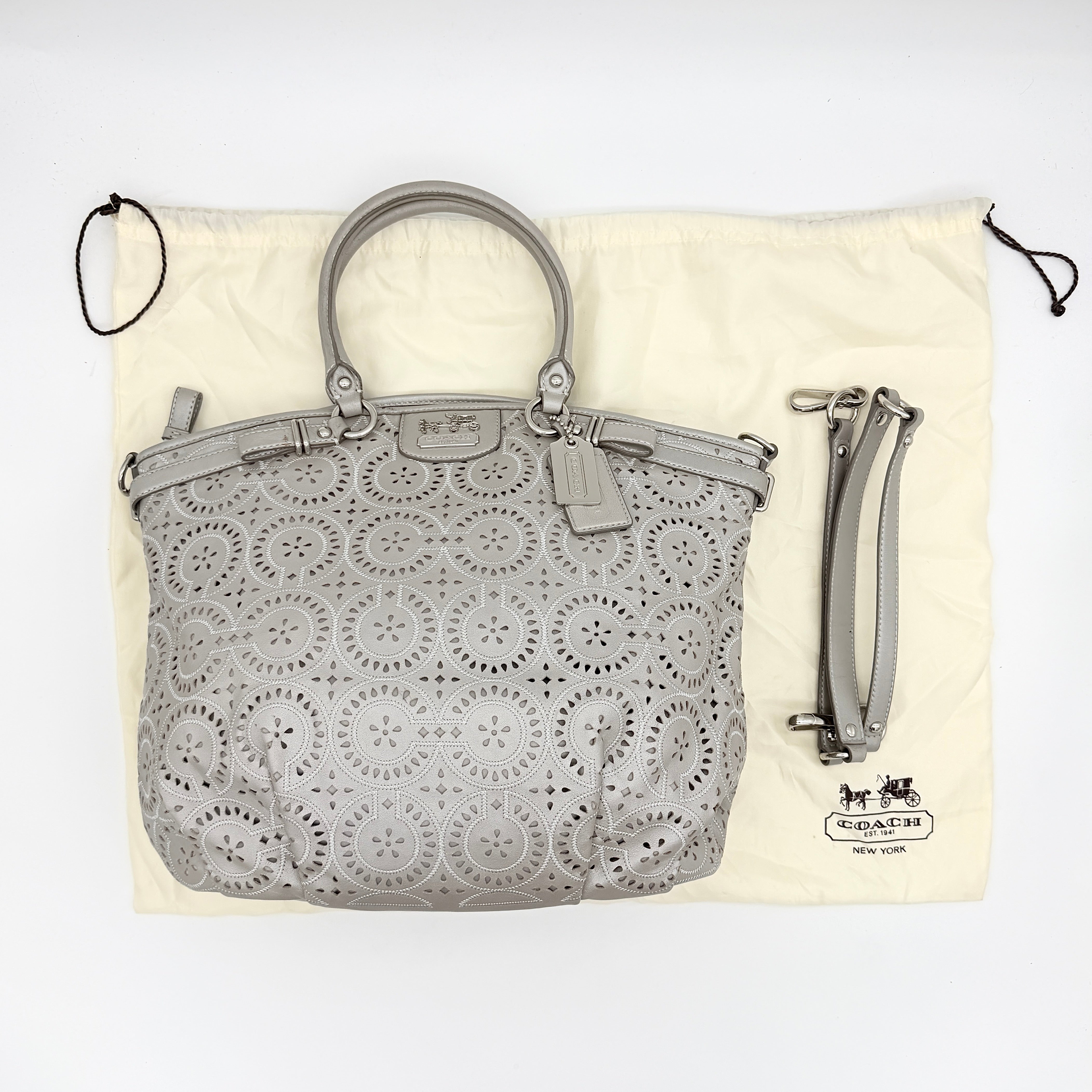 Coach Madison Sophia Shoulder Bag in silver leather with intricate cutout details, shown with original dust bag and detachable strap.