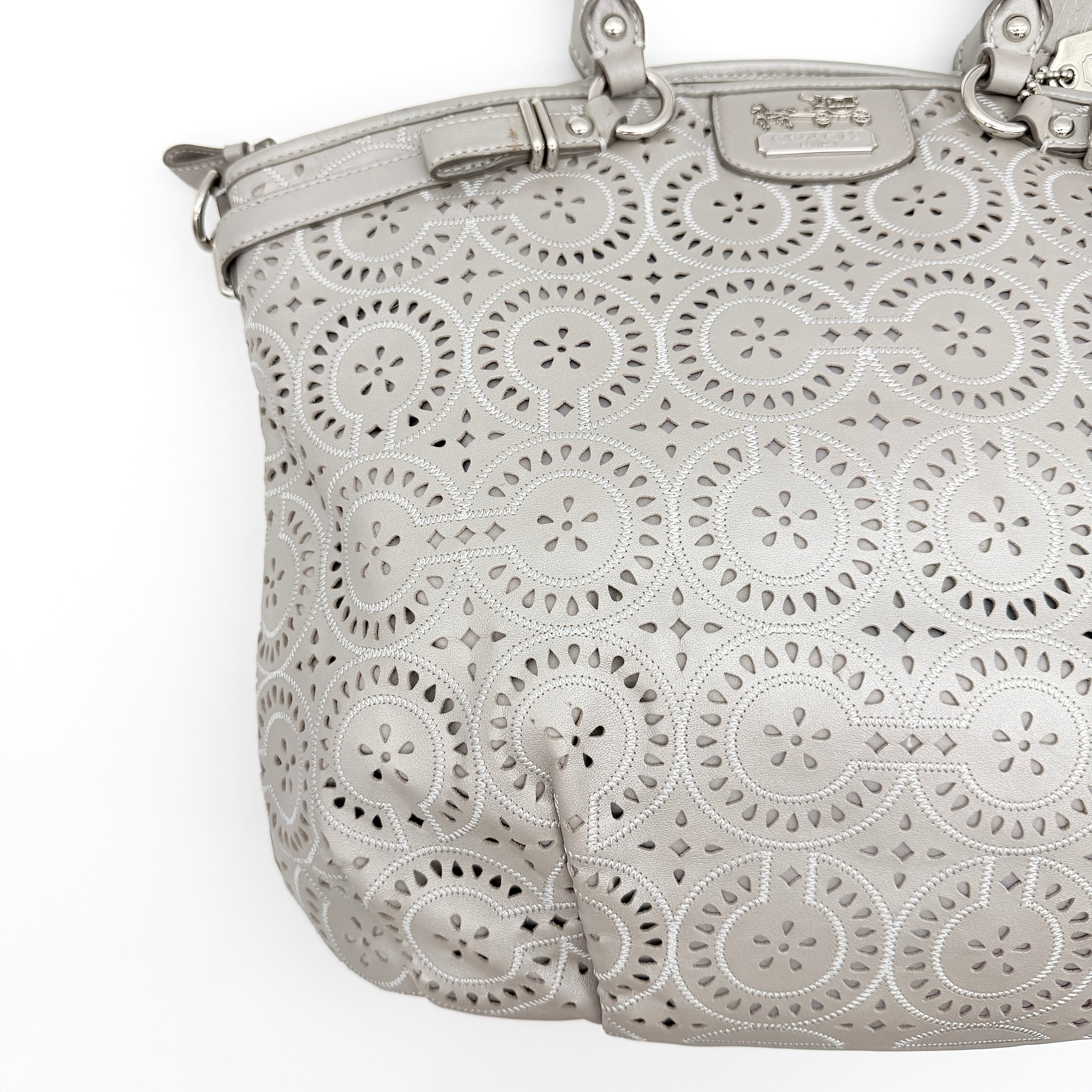 Coach Madison Sophia Shoulder Bag in silver leather with intricate cutout details, shown with original dust bag and detachable strap.