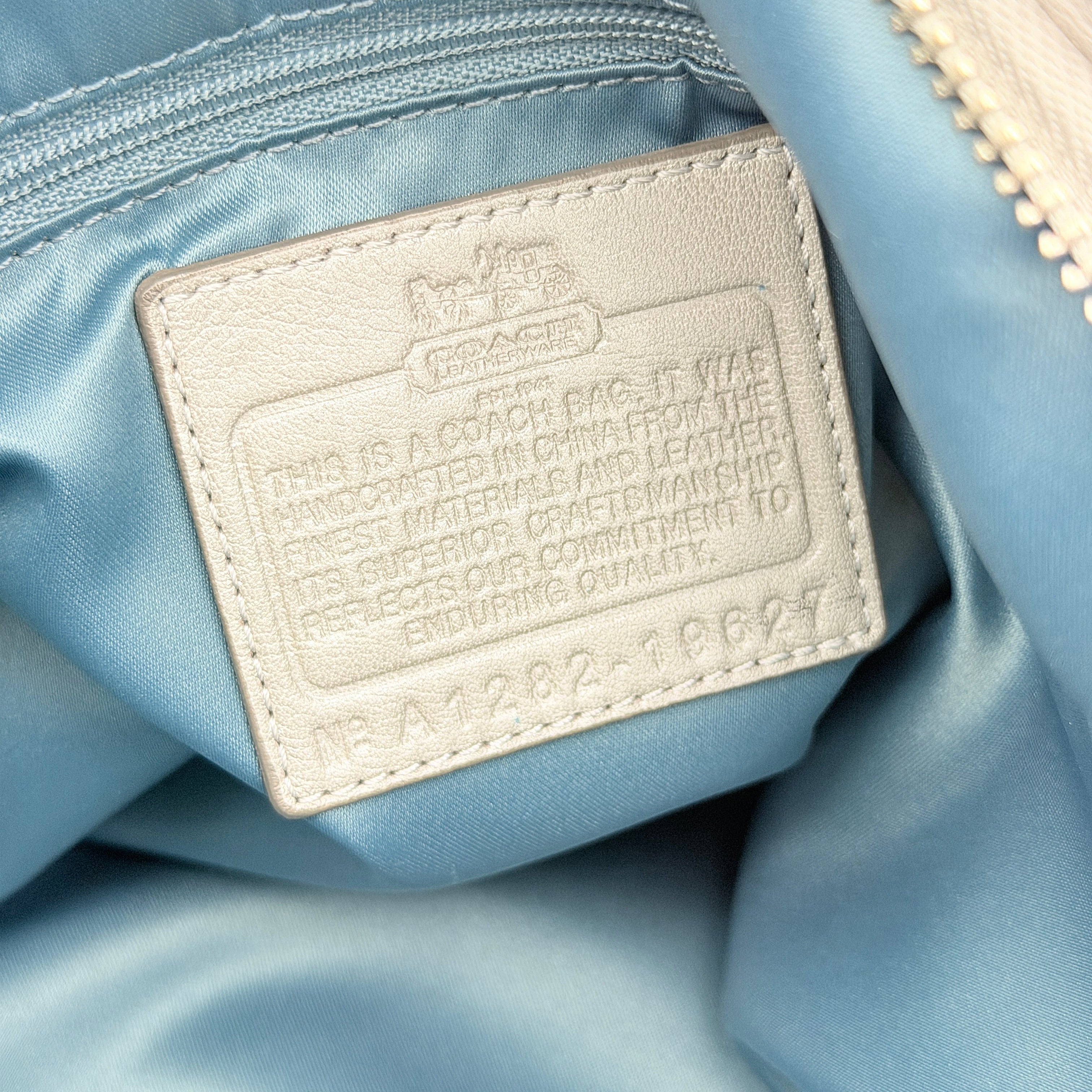 Coach Madison Sophia Shoulder Bag in silver leather with intricate cutout details, shown with original dust bag and detachable strap.