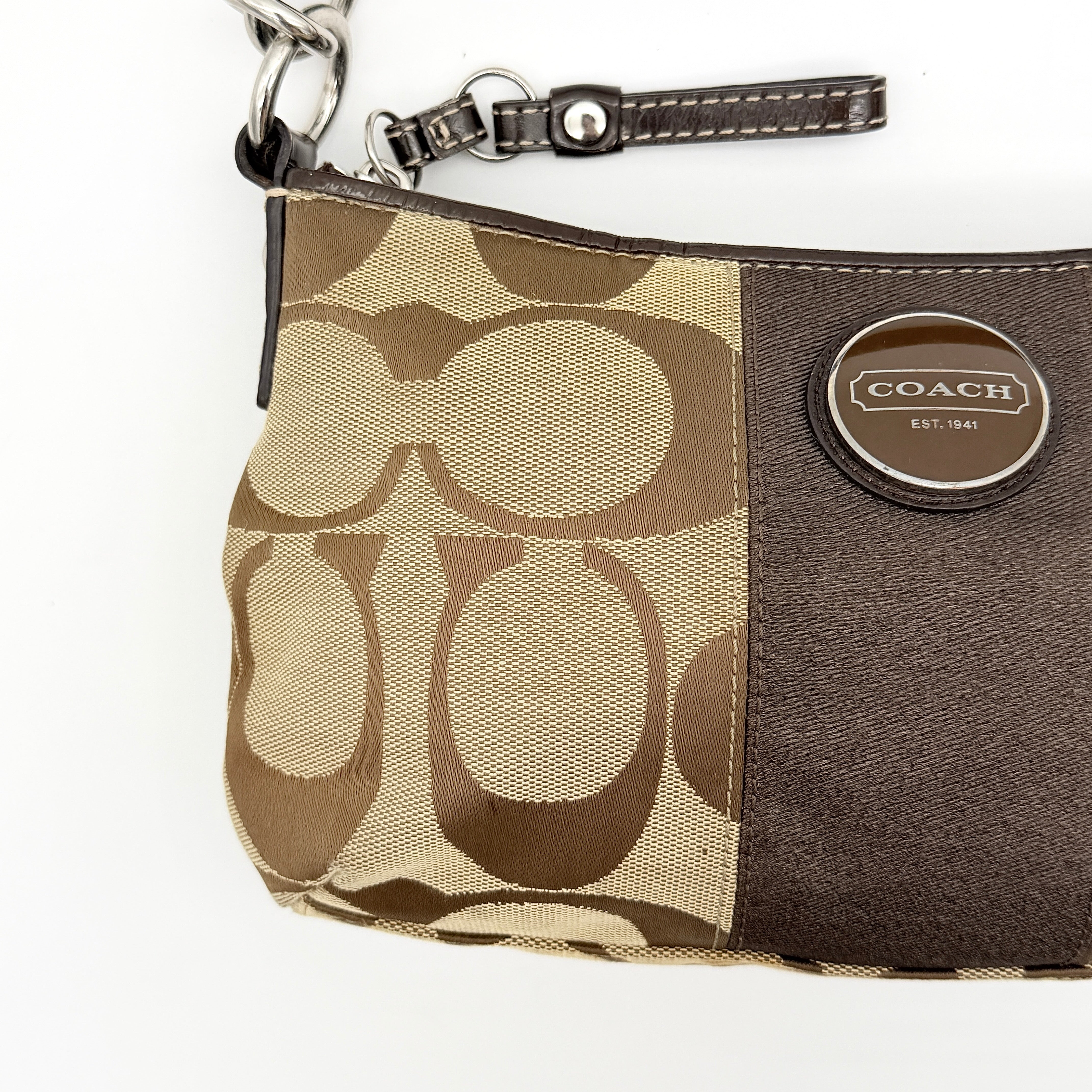 Coach beige and brown 2Way Signature Stripe shoulder bag with silver hardware, leather trim, and detachable straps.