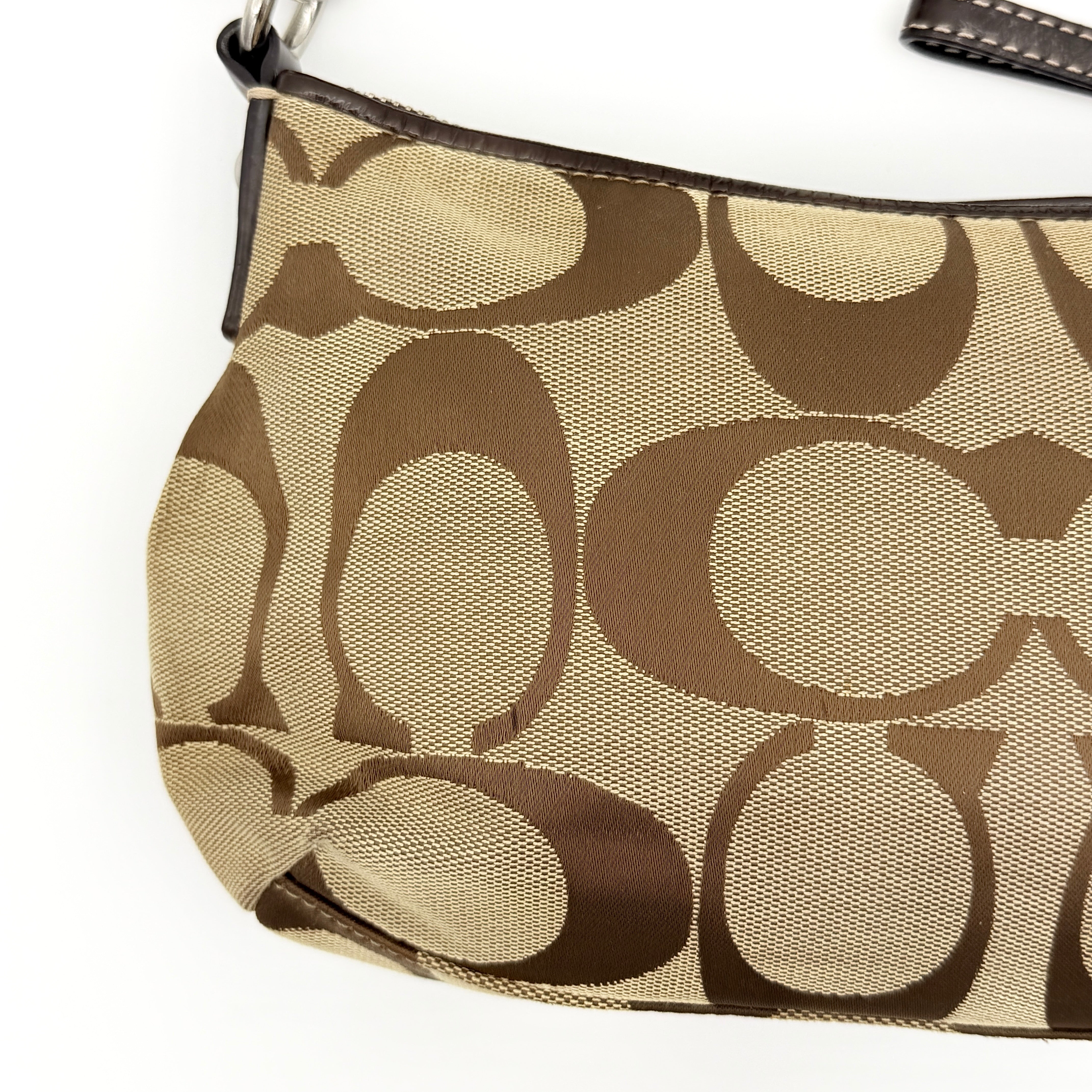Coach beige and brown 2Way Signature Stripe shoulder bag with silver hardware, leather trim, and detachable straps.