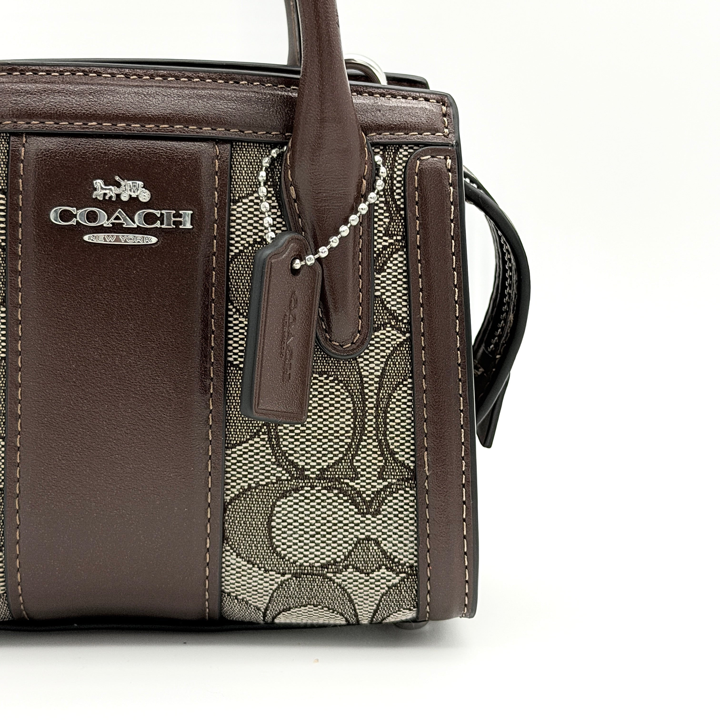 Front view of the Coach Signature Mini Andrea Carryall Shoulder Bag in brown canvas and leather with silver hardware.