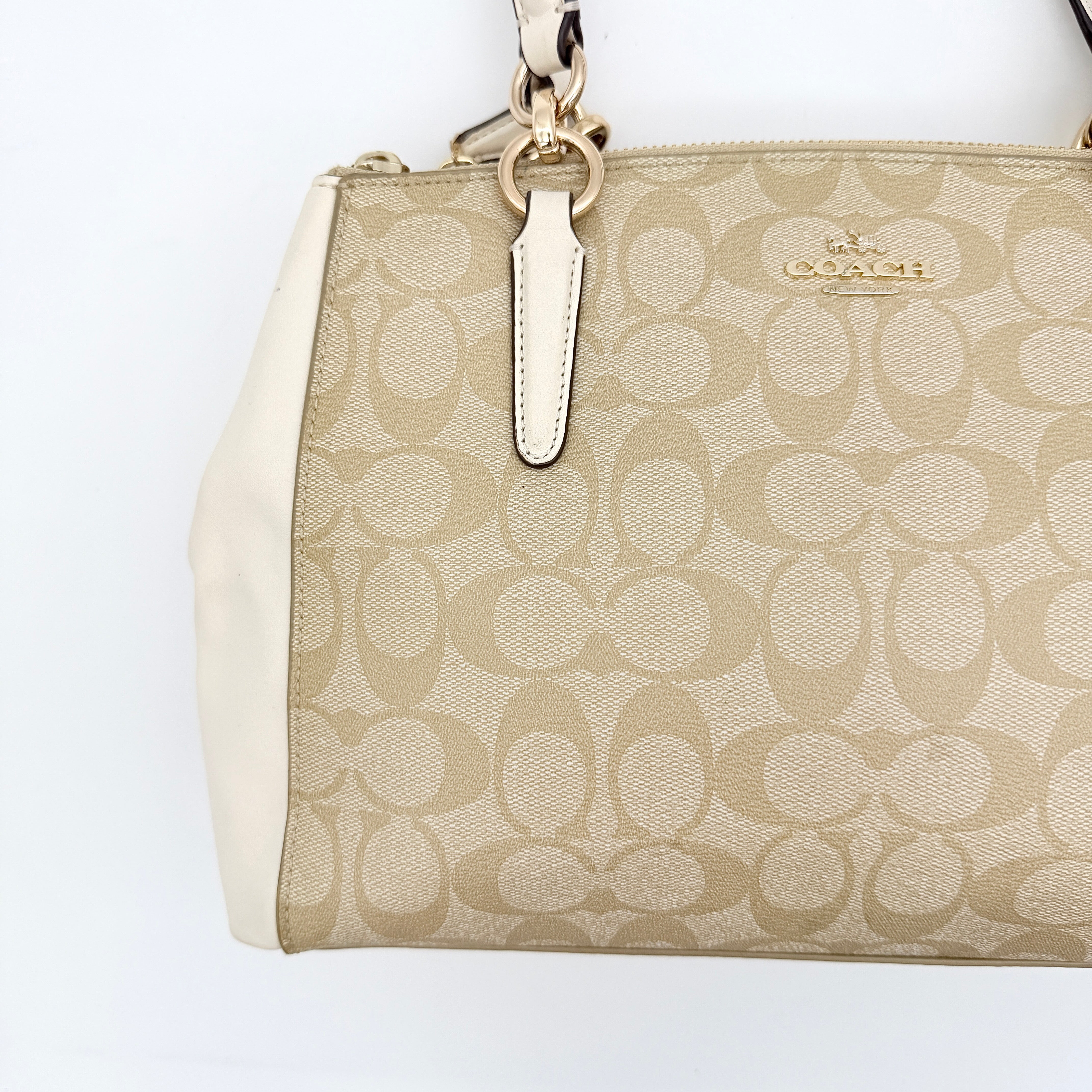 Coach Signature Christie Carryall in beige jacquard with white leather panels, double handles, and detachable strap.