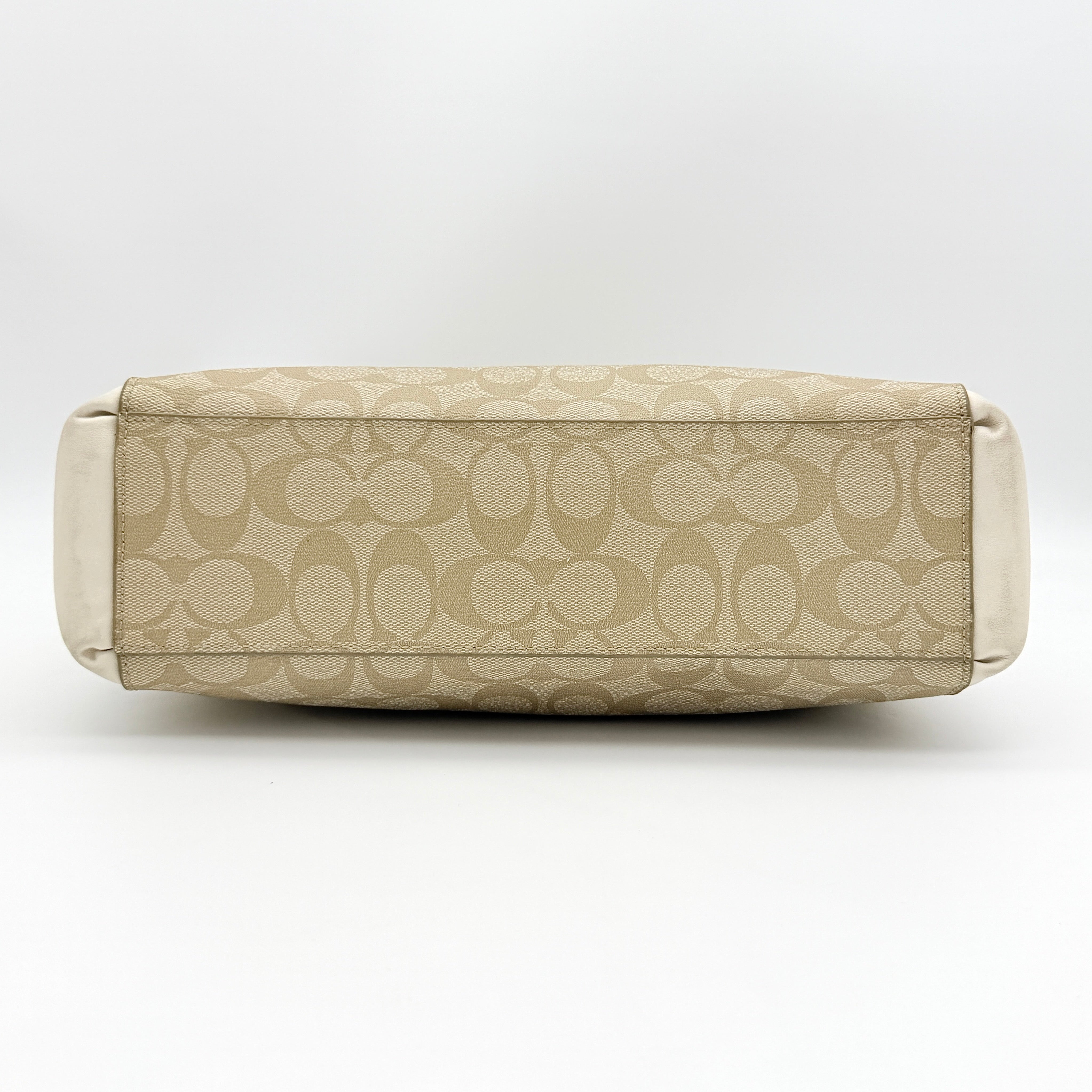 Coach Signature Christie Carryall in beige jacquard with white leather panels, double handles, and detachable strap.