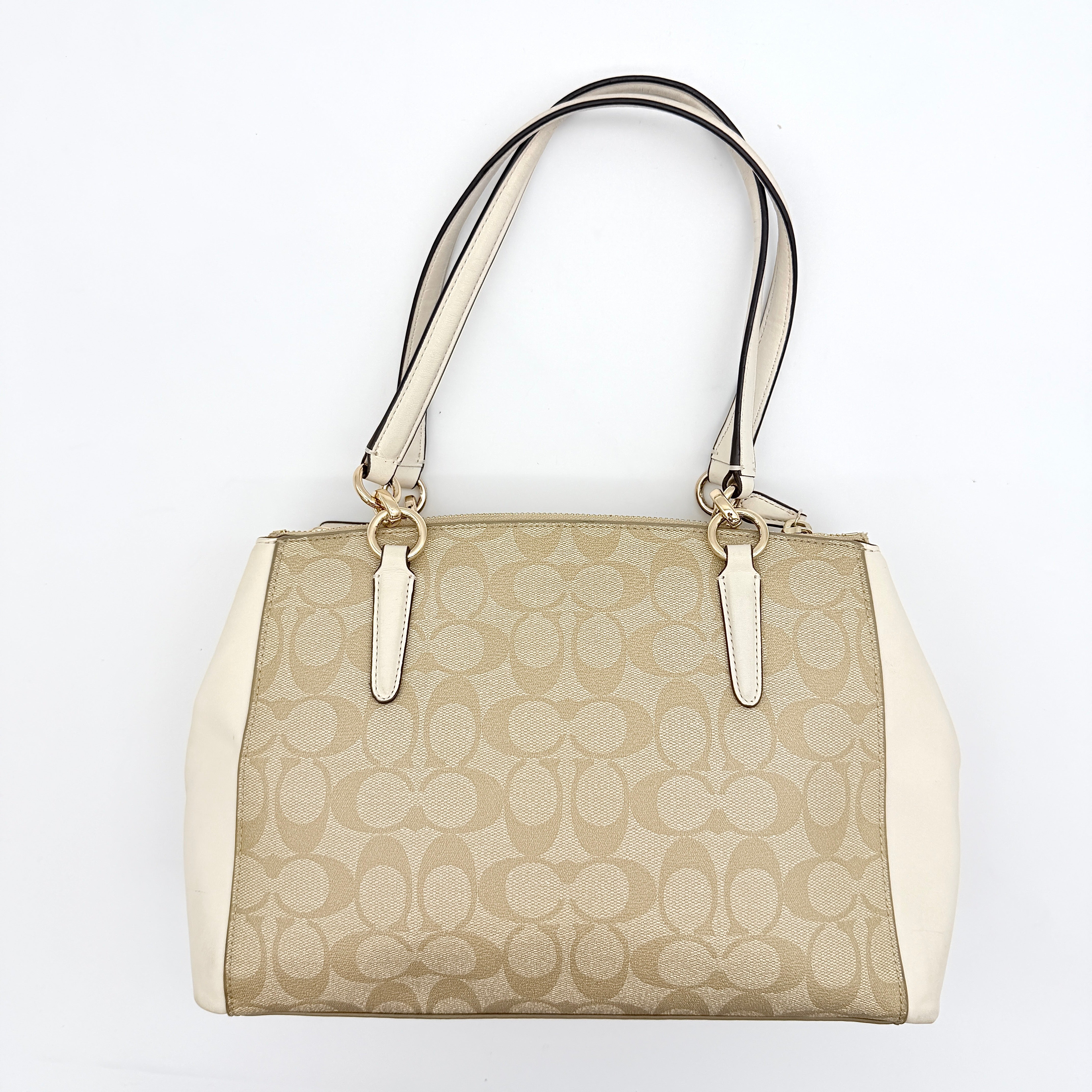 Coach Signature Christie Carryall in beige jacquard with white leather panels, double handles, and detachable strap.