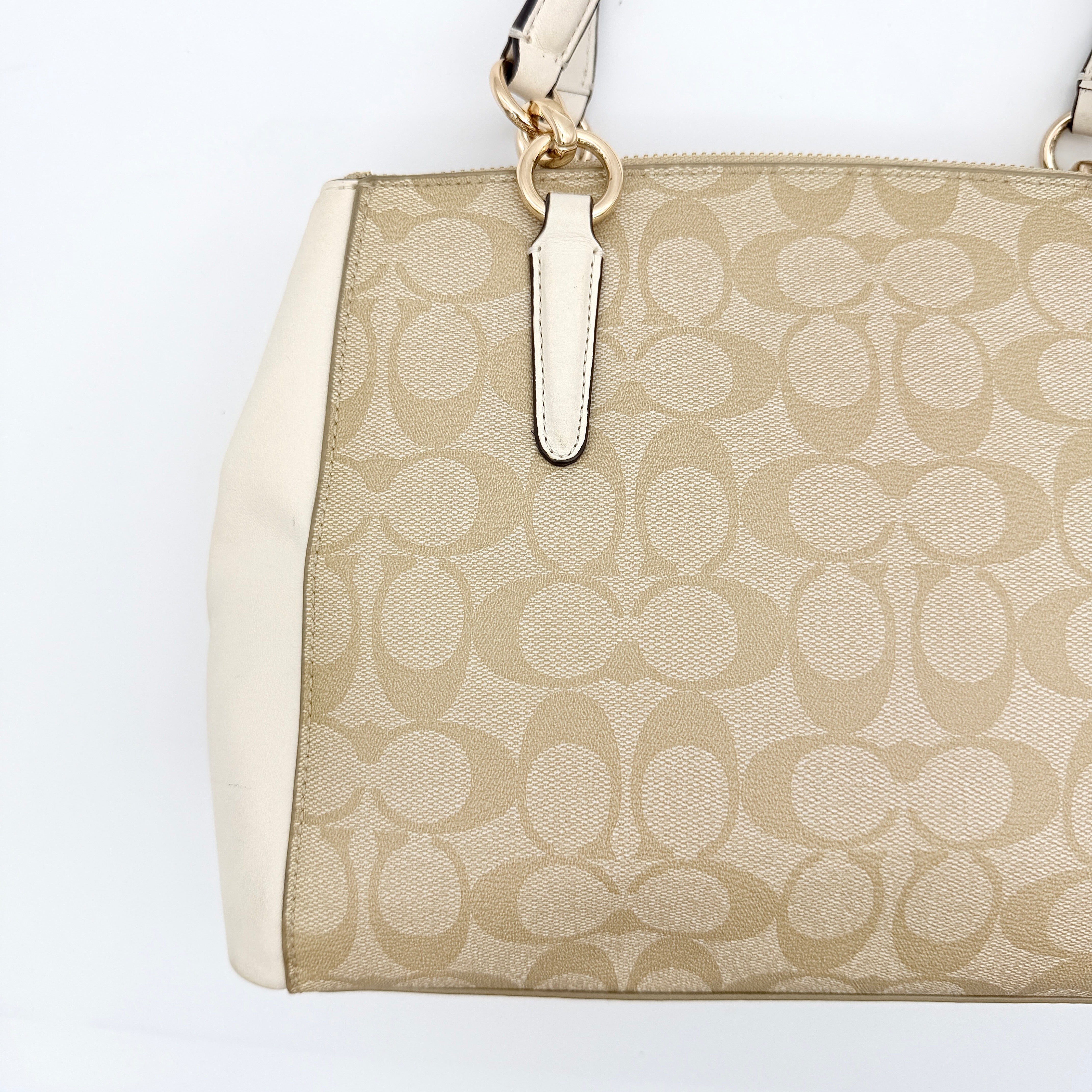 Coach Signature Christie Carryall in beige jacquard with white leather panels, double handles, and detachable strap.