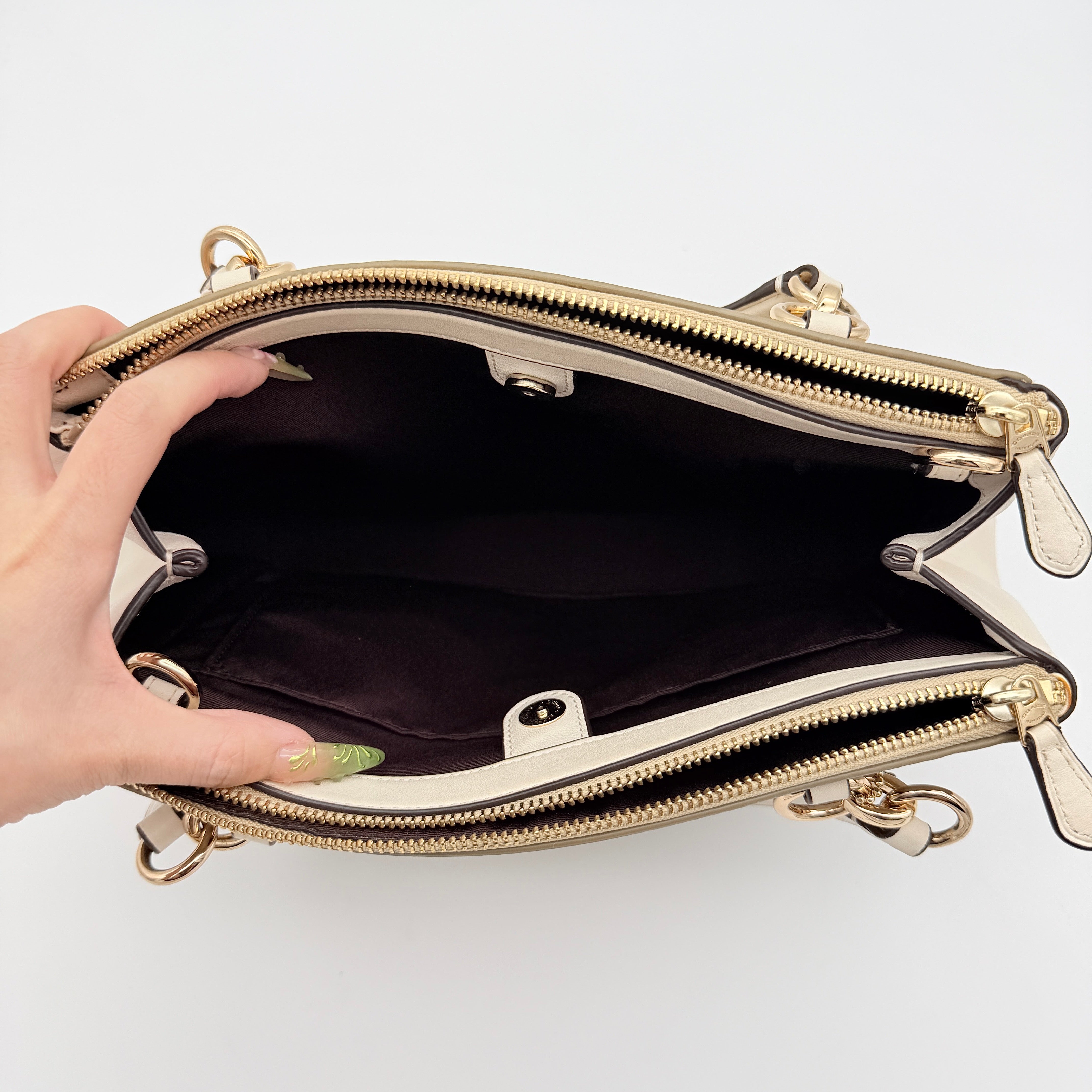 Coach Signature Christie Carryall in beige jacquard with white leather panels, double handles, and detachable strap.