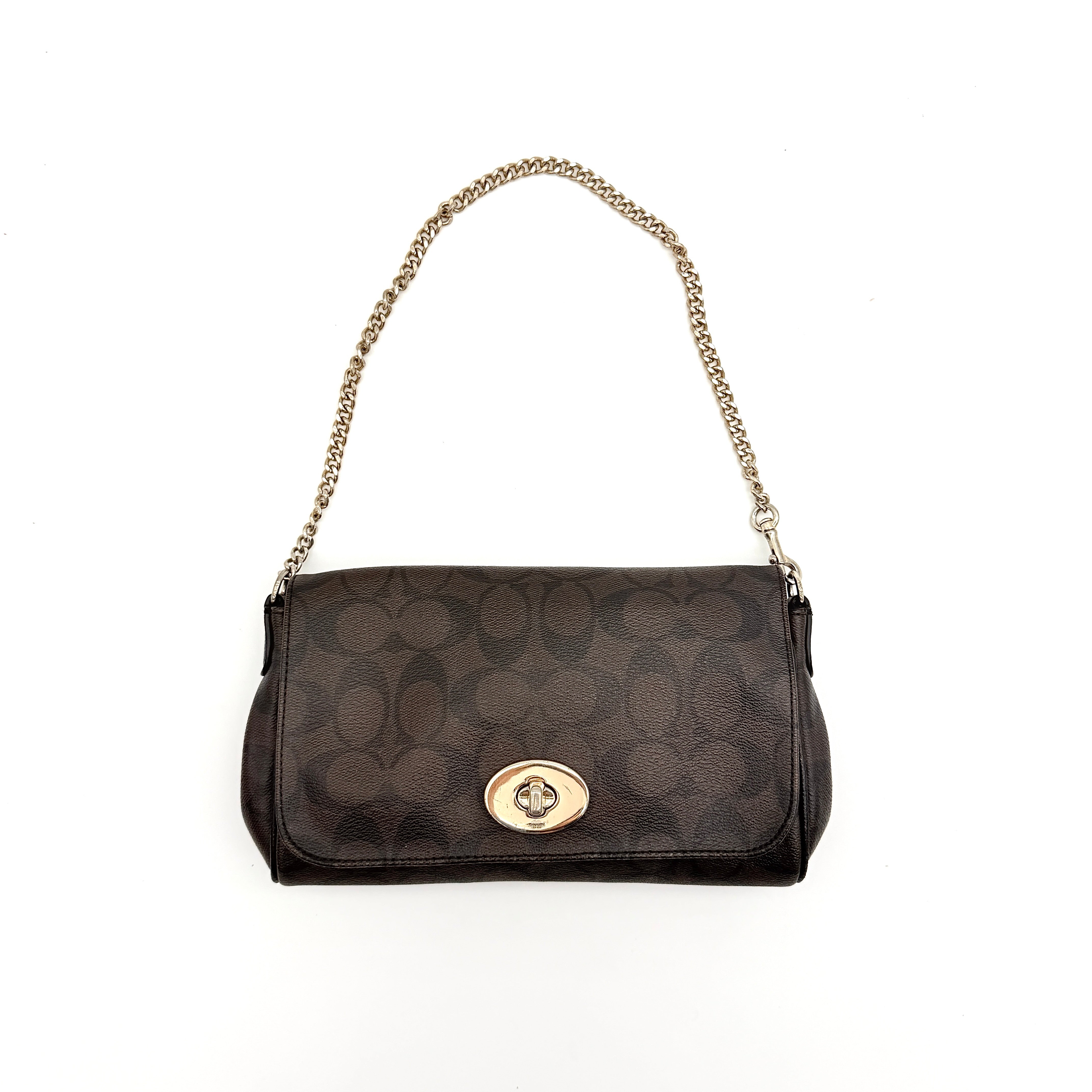 Coach Signature Ruby shoulder bag in brown and black with gold chain strap and detachable leather crossbody strap, displayed on a white background.