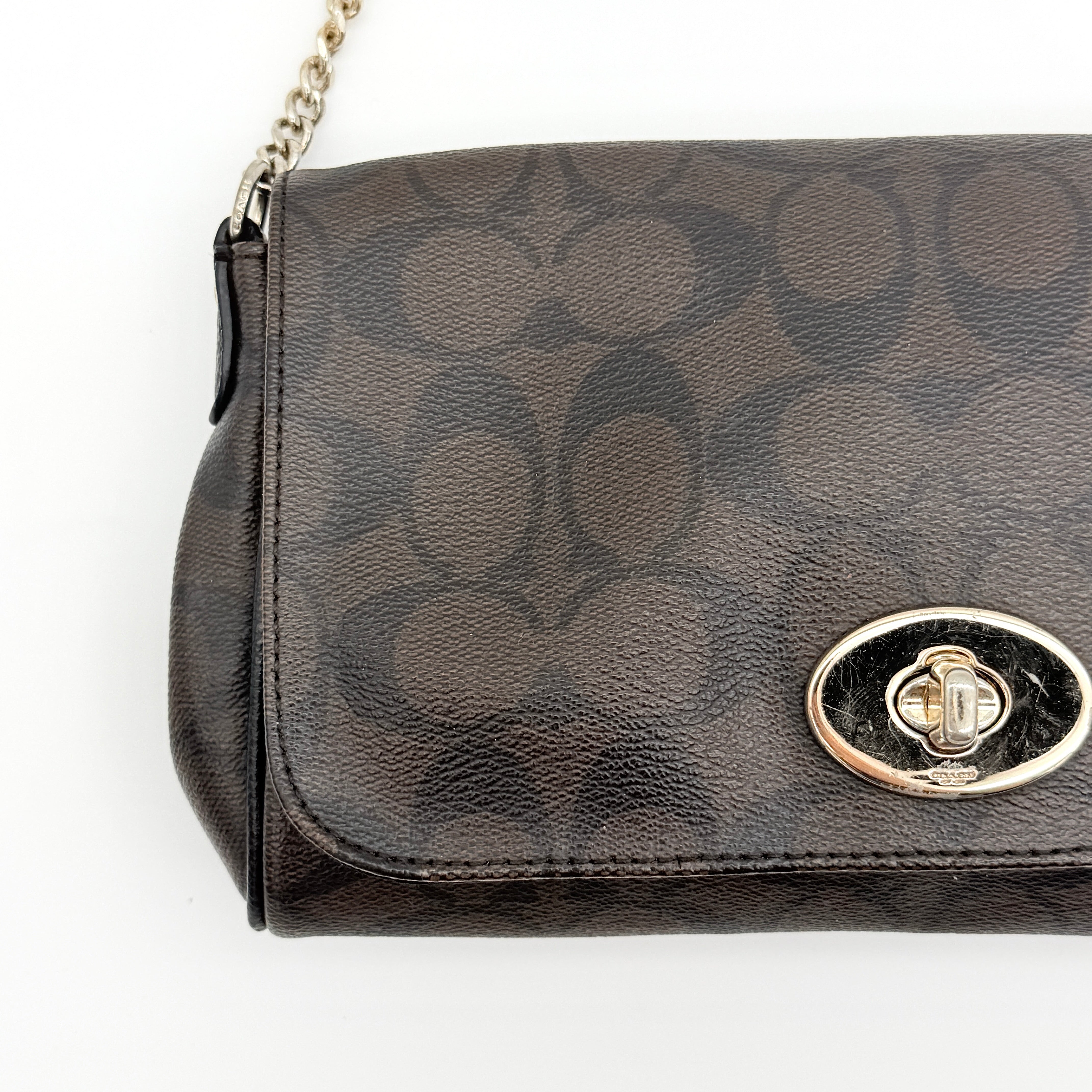 Coach Signature Ruby shoulder bag in brown and black with gold chain strap and detachable leather crossbody strap, displayed on a white background.