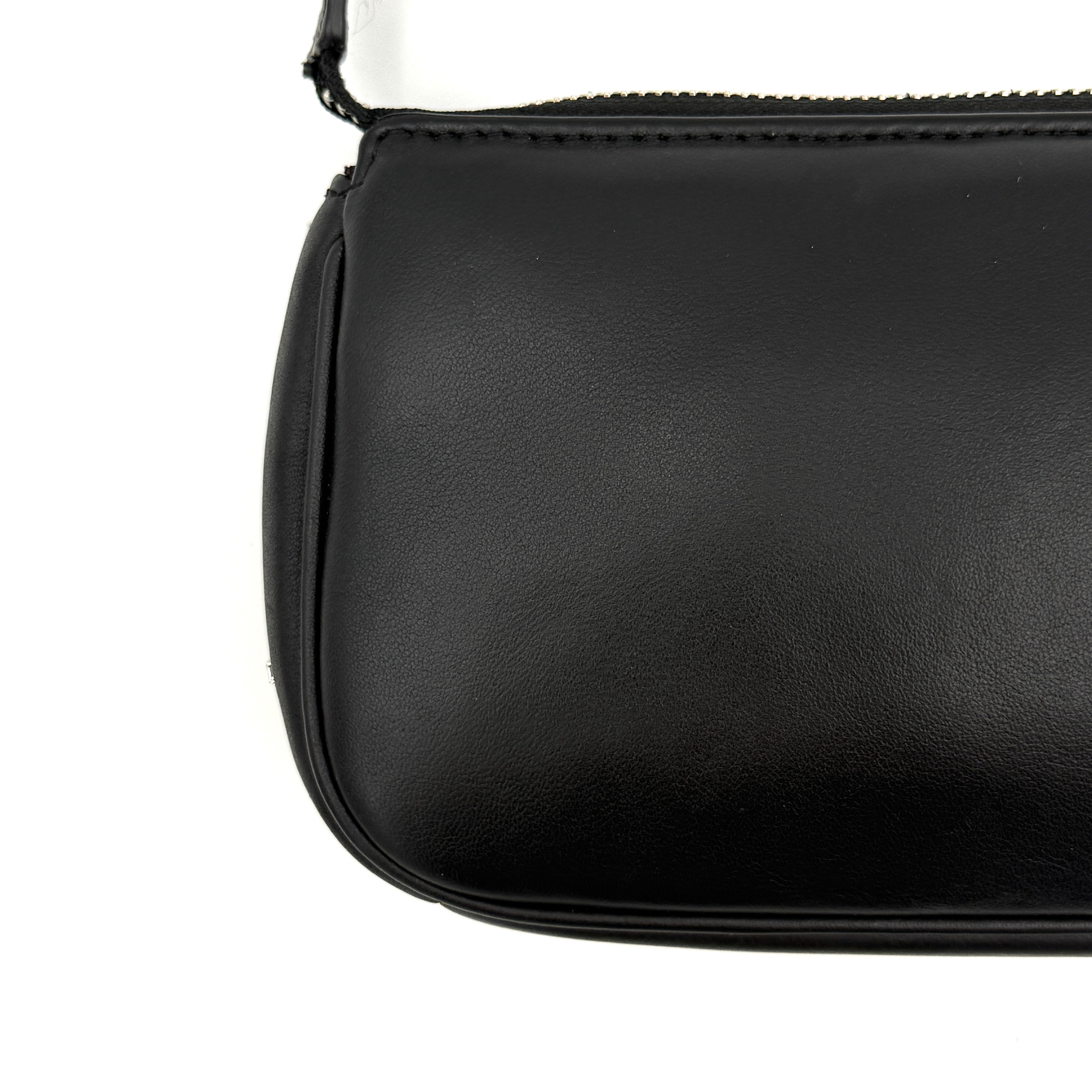 Coach Nolita 19 shoulder bag in quilted black leather with a bold stitched 'C' emblem and chunky silver chain strap.