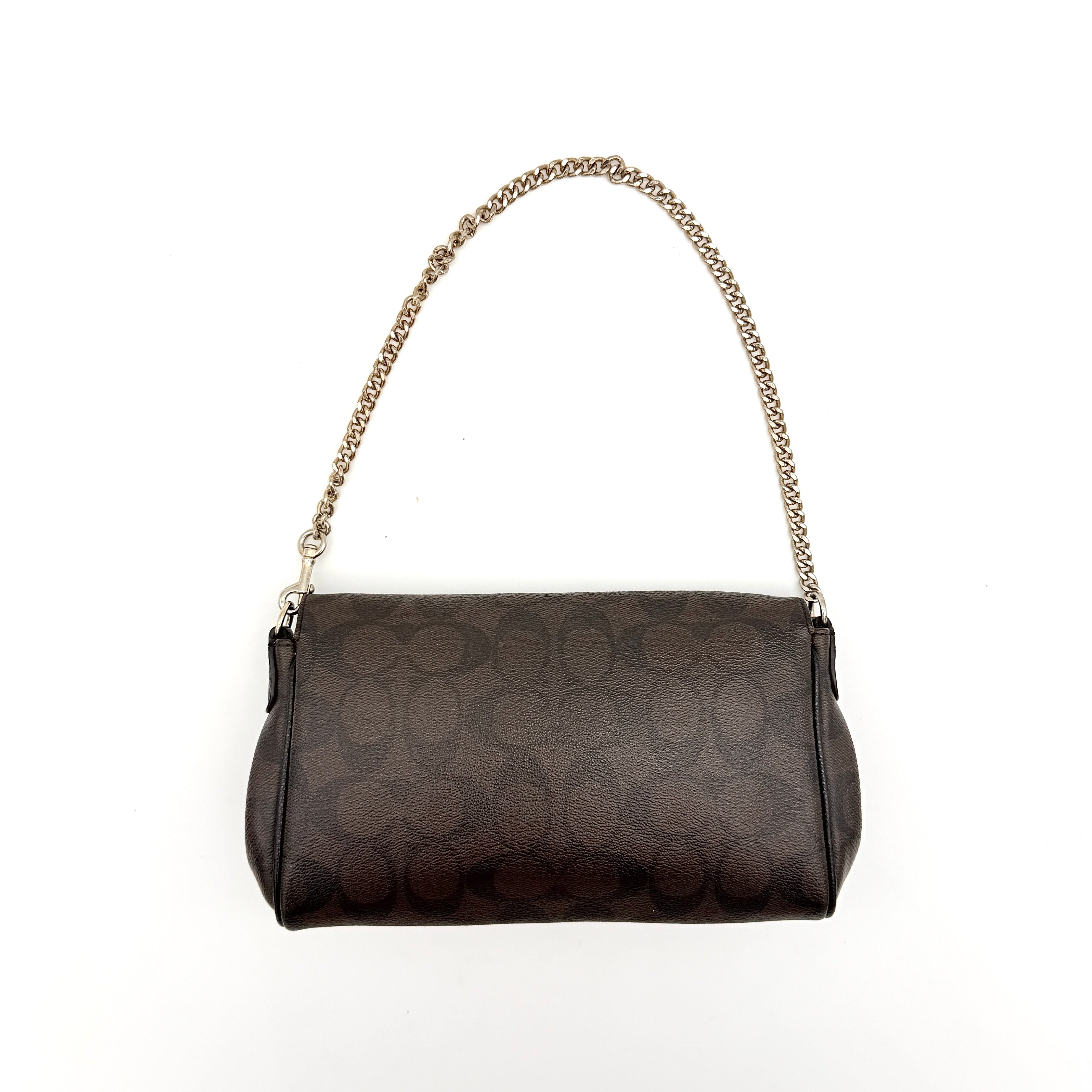 Coach Signature Ruby shoulder bag in brown and black with gold chain strap and detachable leather crossbody strap, displayed on a white background.